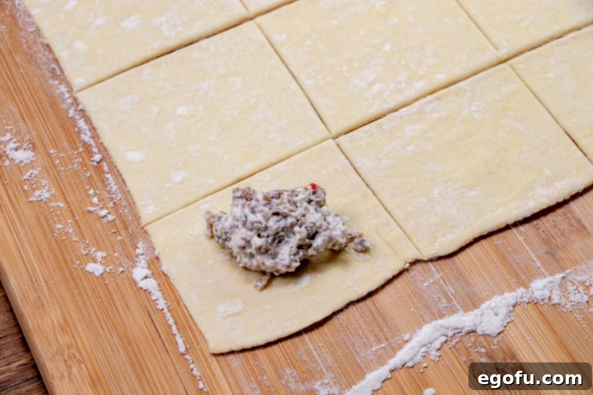 Sausage Rolls with Flaky Pastry 8 A dollop of creamy sausage mixture on top of a puff pastry square.
