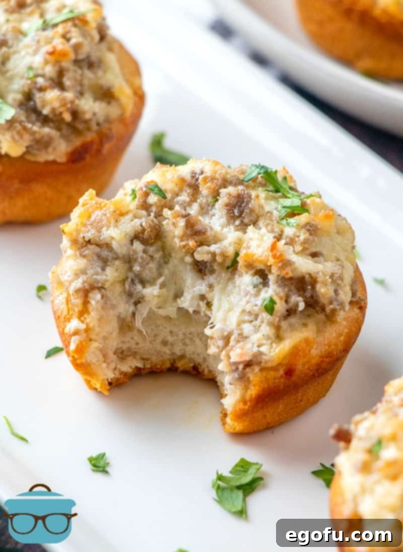 Cream Cheese Sausage Stuffed Biscuits on a white serving platter.