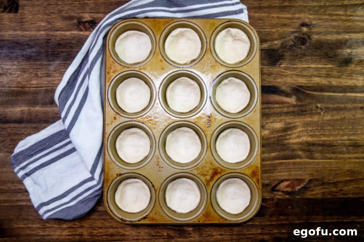 Refrigerated biscuits placed into each muffin hole in a 12-cup muffin tin.