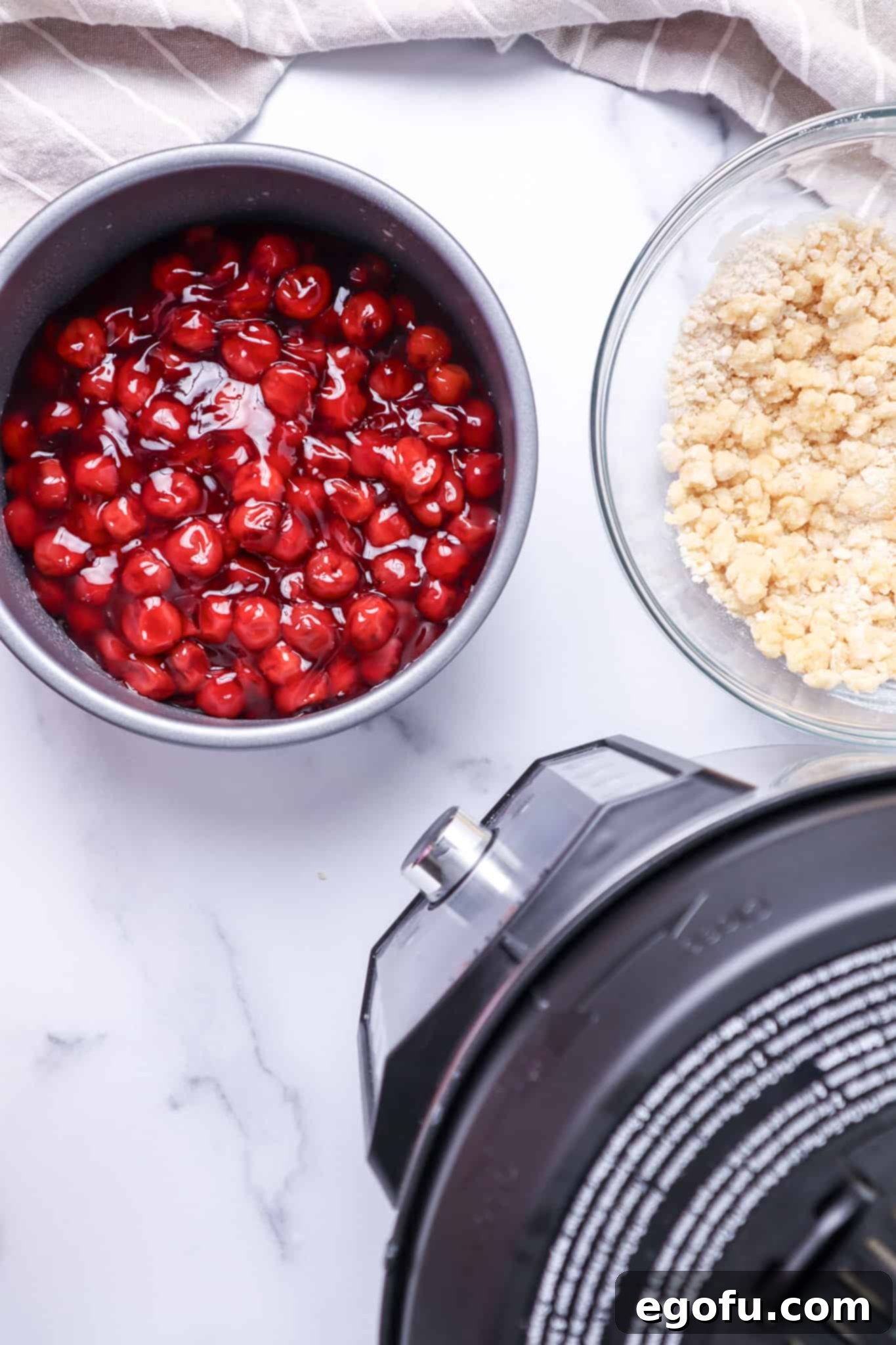cherry pie filling poured into the bottom of a 7-inch metal pie pan.