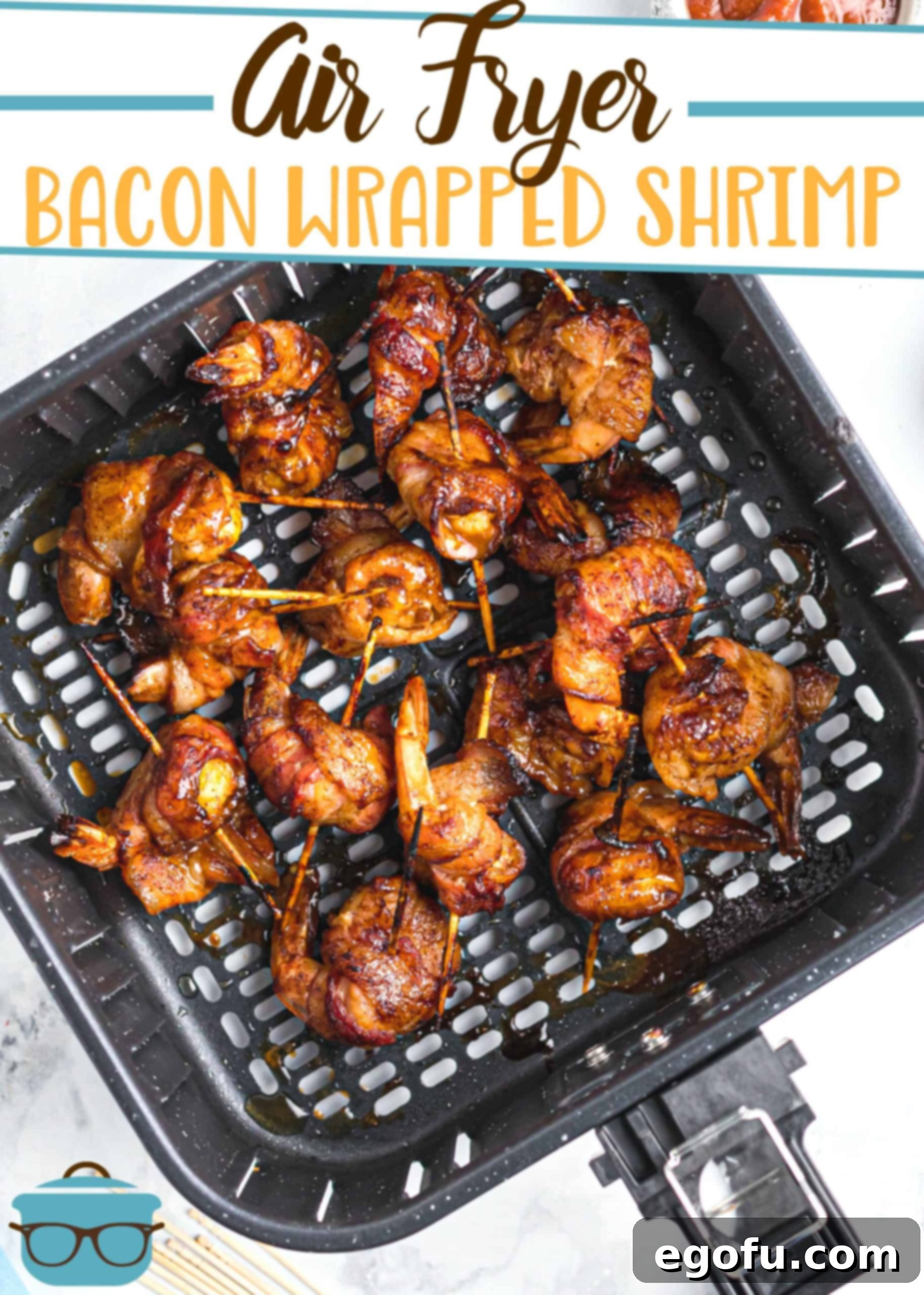 AIR FRYER BACON WRAPPED SHRIMP recipe from The Country Cook, pictured, cooked shrimp in an air fryer basket.