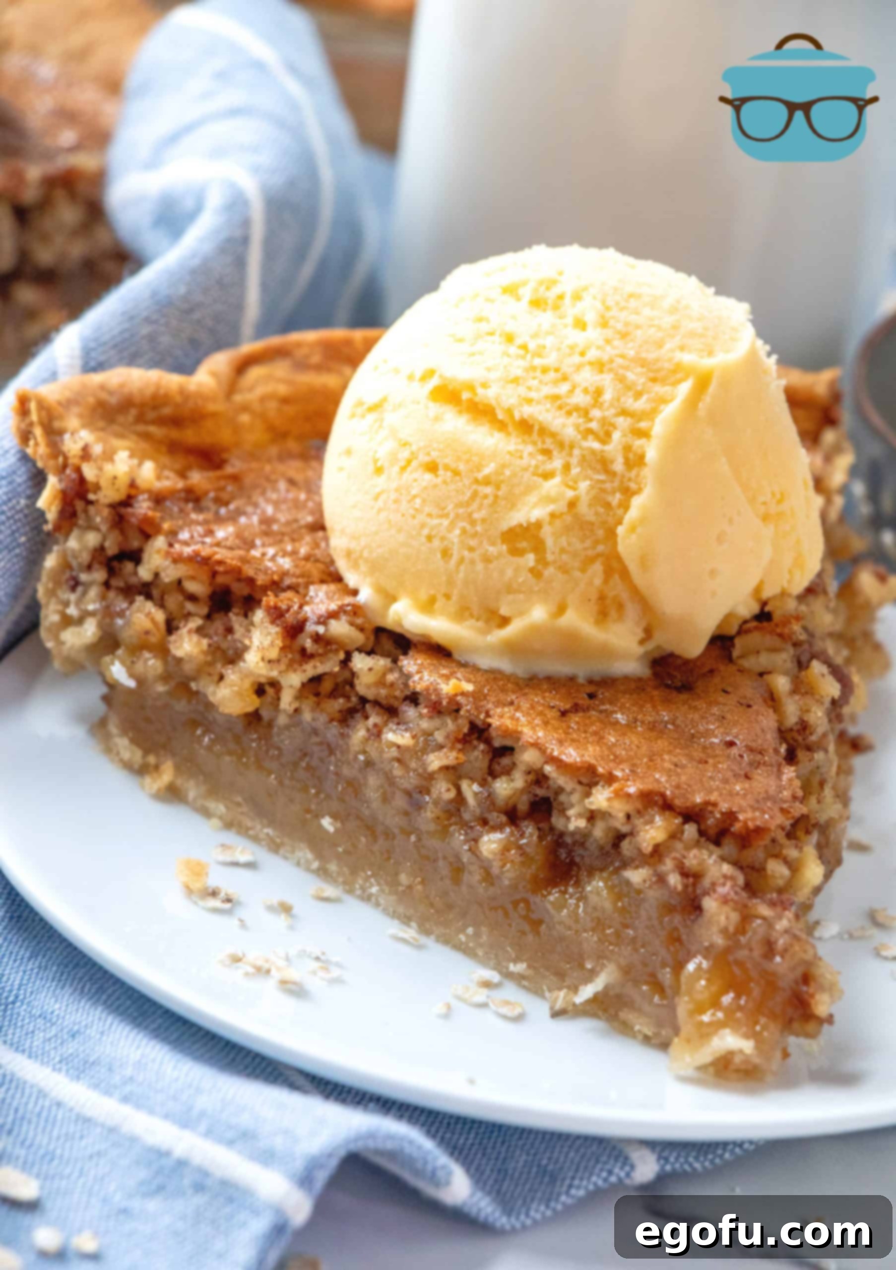 slice of Oatmeal Pie on a plate and topped with a scoop of ice cream