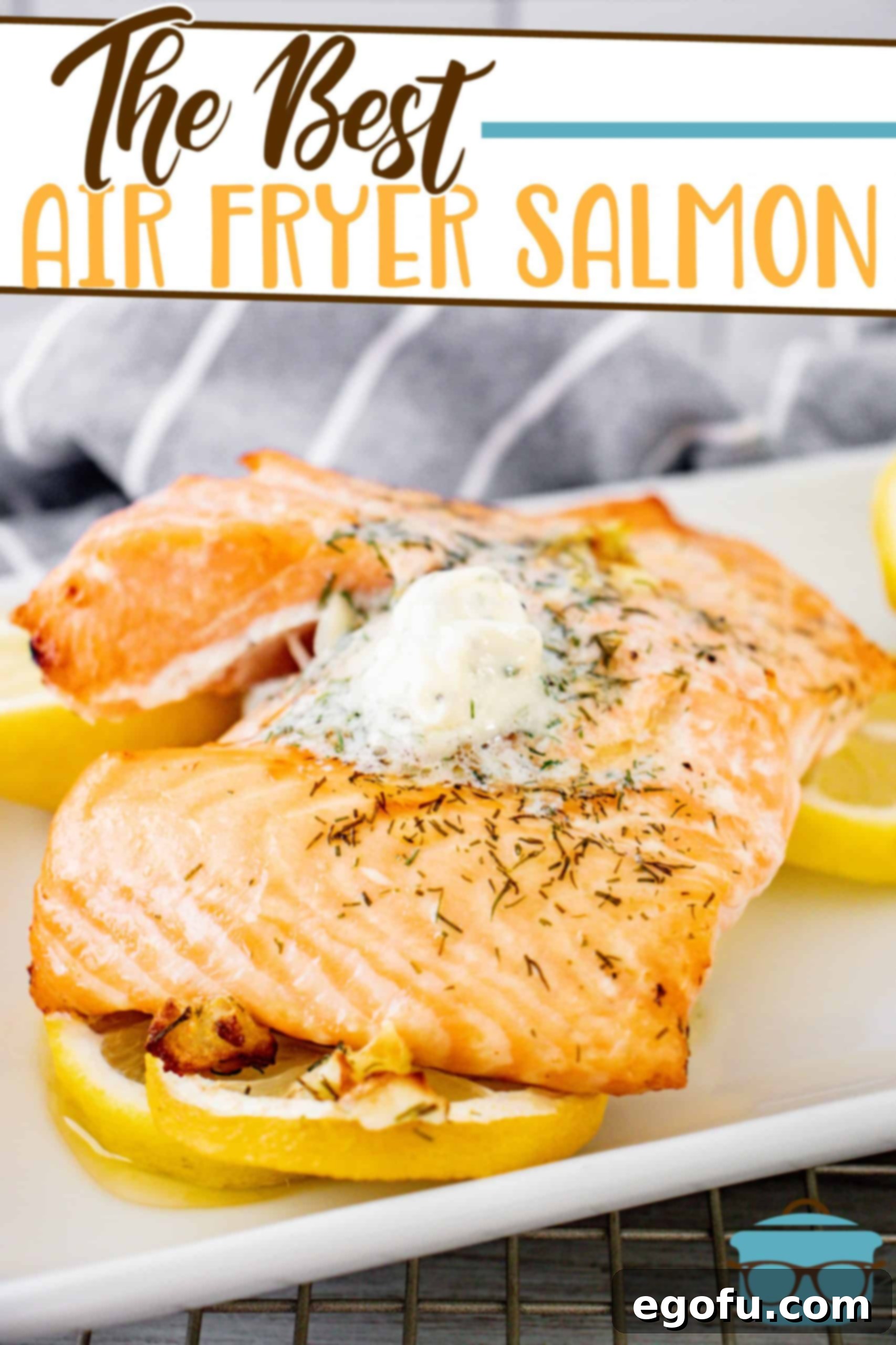 Air Fryer Salmon Perfection 2 A perfectly cooked Air Fryer Salmon fillet with lemon garlic dill butter, beautifully presented on a white plate atop a bed of sliced lemons, ready to be served.