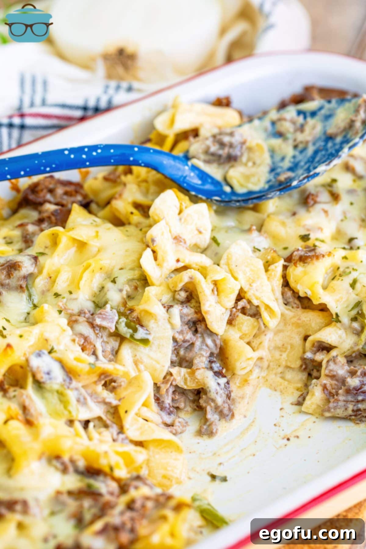 A casserole dish with some Philly Cheesesteak Casserole still in it.