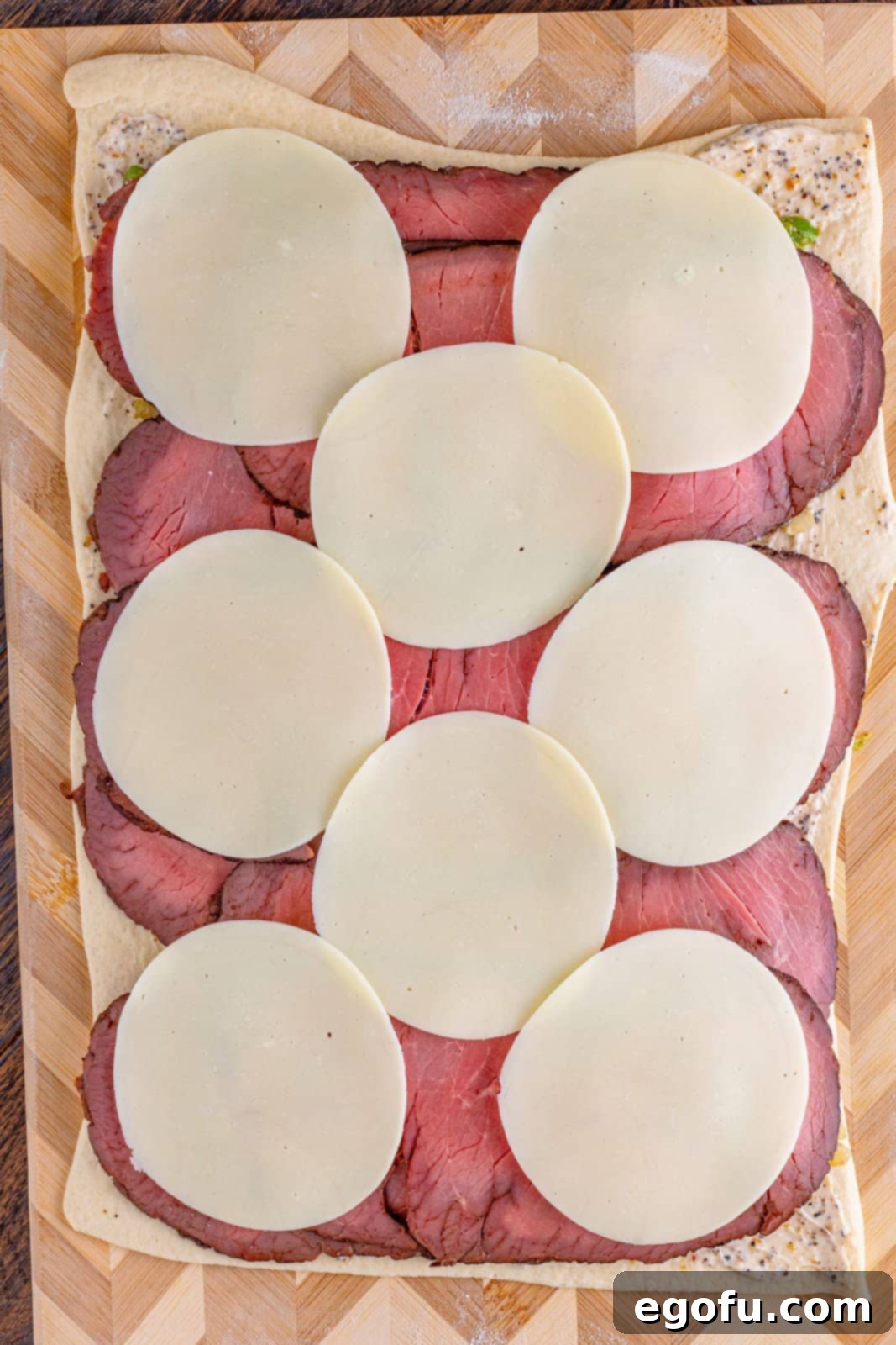 Philly Cheesesteak Pinwheels 11 slices of provolone layered across sliced roast beef.