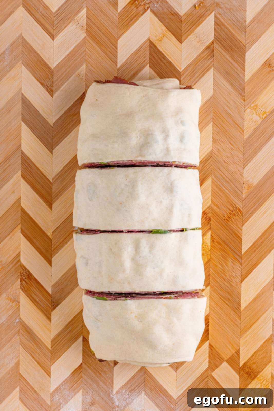 Philly Cheesesteak Pinwheels 13 cheesesteak log cut into four large pieces.