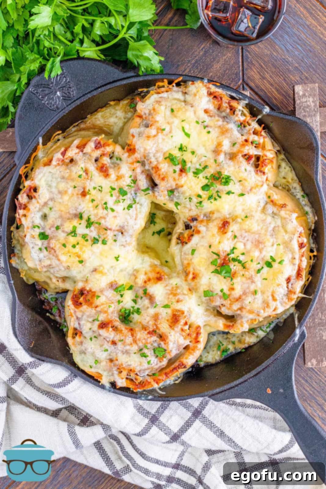 Philly Cheesesteak Pinwheels 16 melted cheese on rollups shown in cast iron skillet.