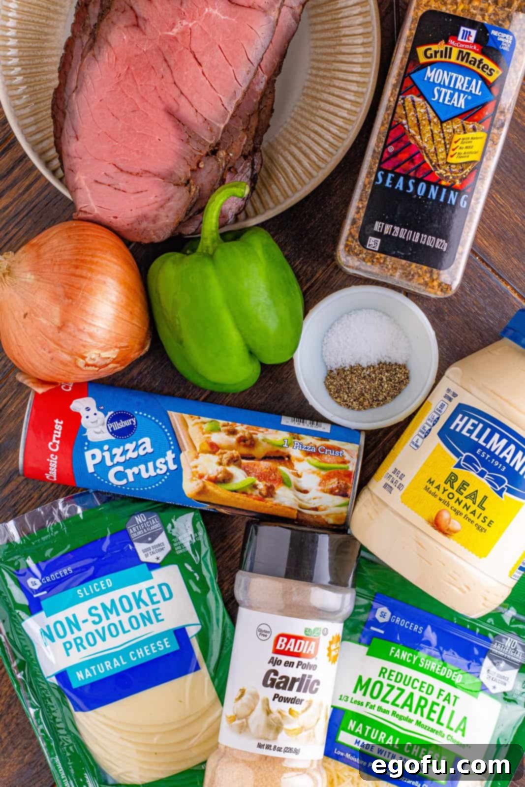 Philly Cheesesteak Pinwheels 3 onion, green bell pepper. garlic powder, salt and pepper, Pillsbury pizza dough, mayonnaise, steak seasoning, sliced deli roast beef, provolone cheese, shredded mozzarella cheese.