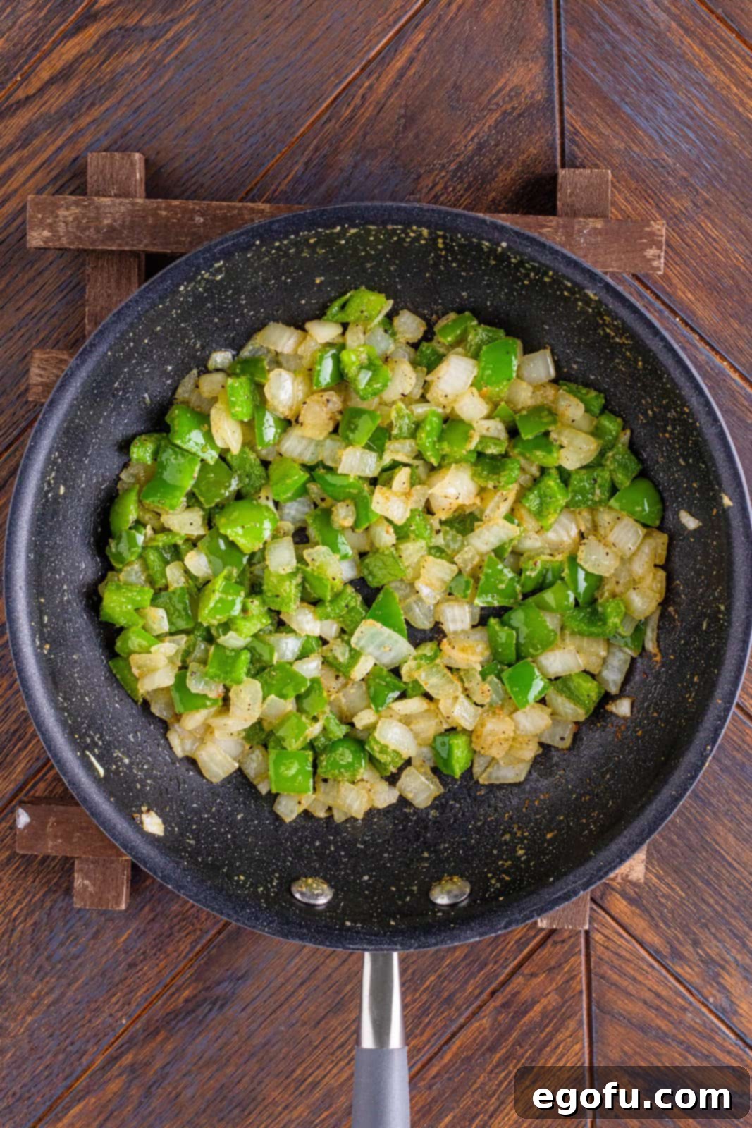 Philly Cheesesteak Pinwheels 5 cooking green peppers and onion in a large skillet.