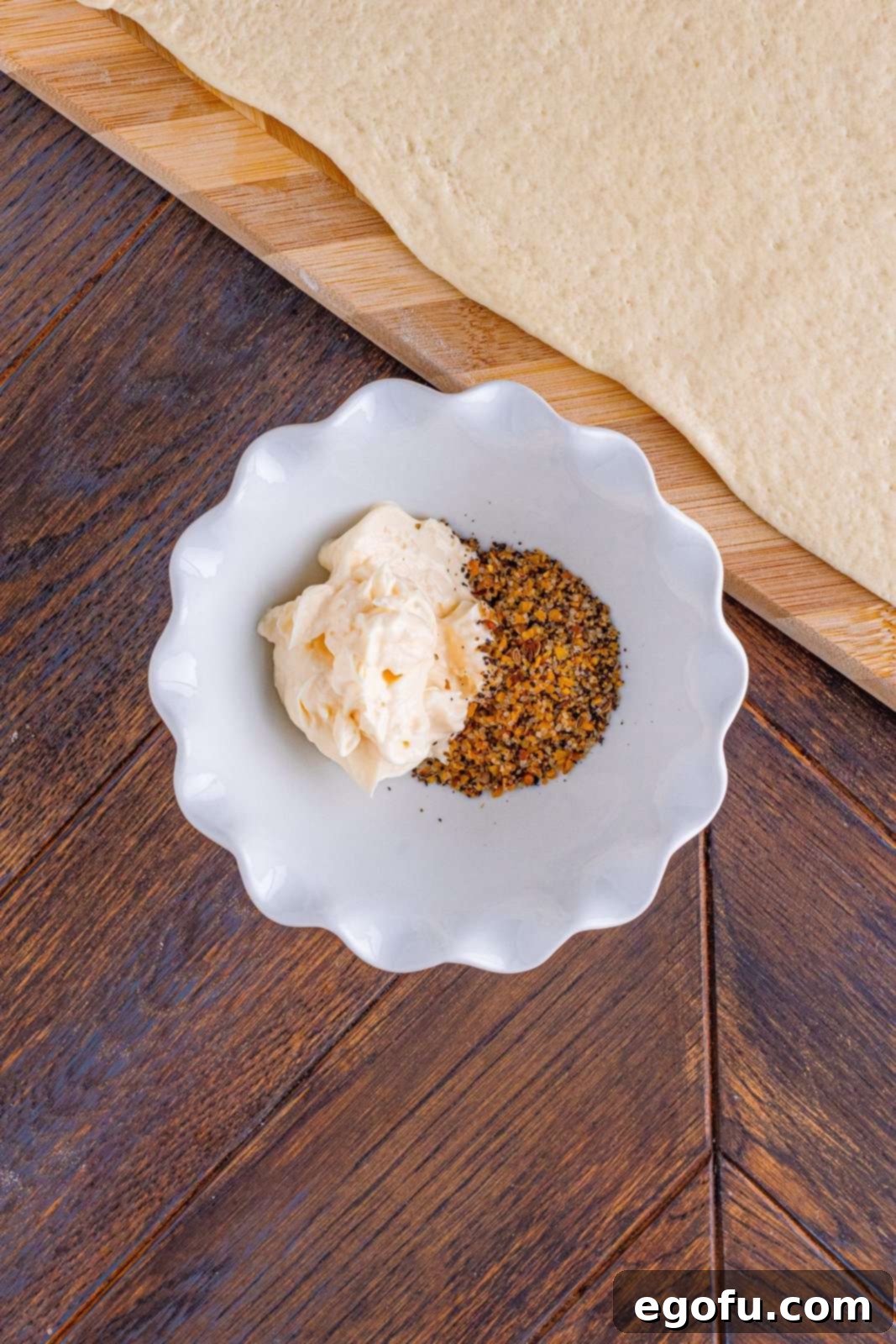 Philly Cheesesteak Pinwheels 7 mayonnaise and steak seasoning in a white bowl.