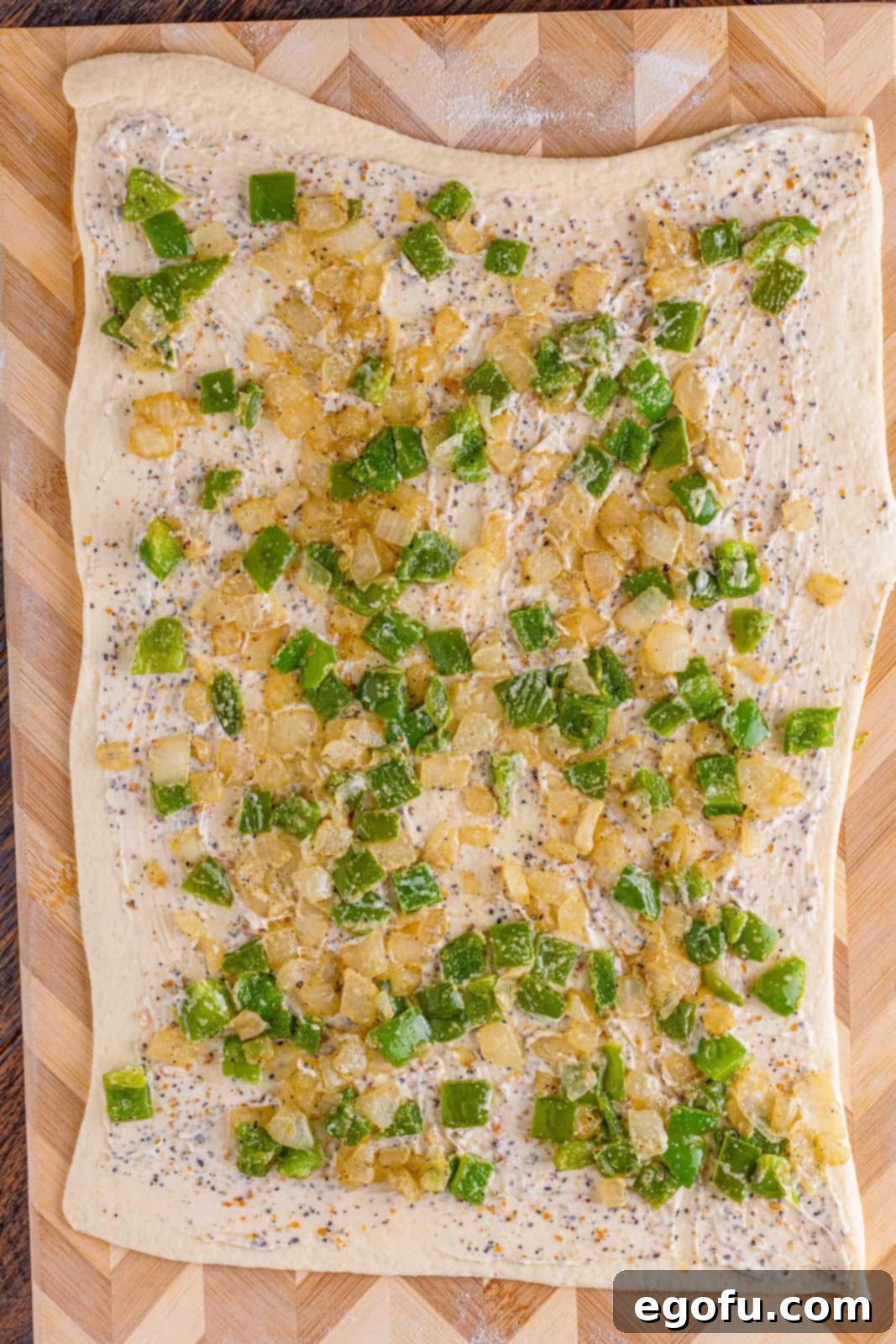 Philly Cheesesteak Pinwheels 9 green peppers and onion on pizza dough.