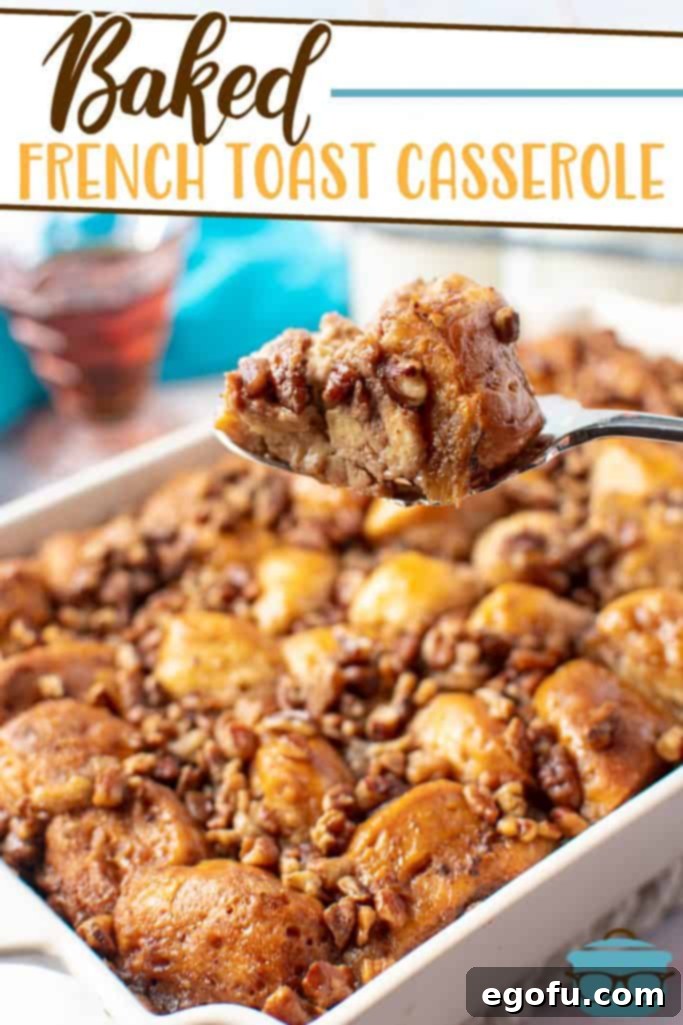 A scoop taken from a creamy baked French toast casserole, showing the biscuit pieces and a rich pecan topping.