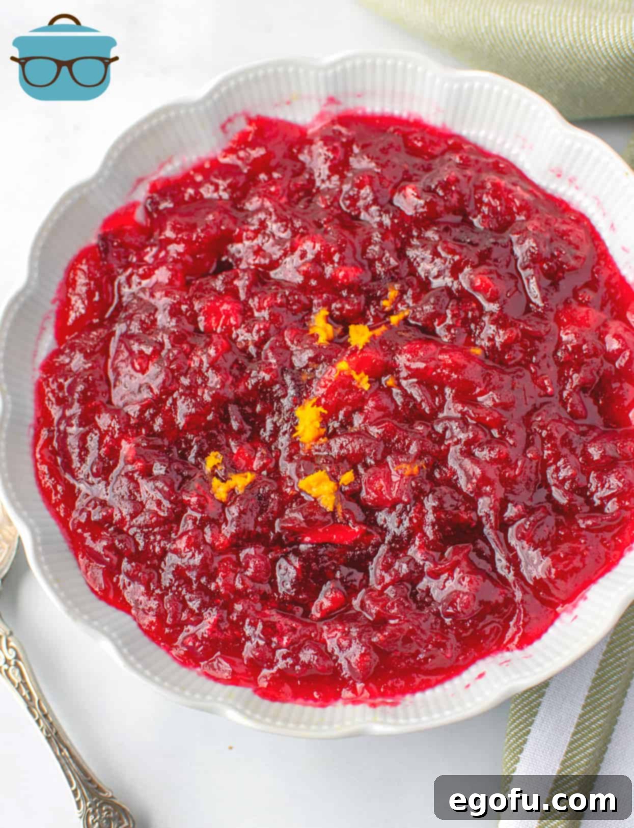 Effortless Cranberry Sauce 2 Homemade Cranberry Sauce in a white bowl and topped with fresh orange zest.
