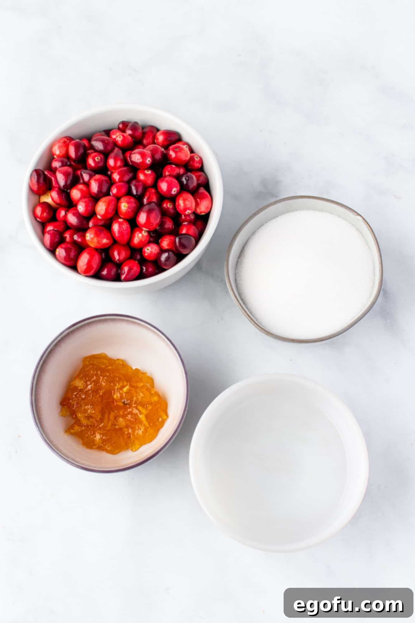 Effortless Cranberry Sauce 4 fresh cranberries, sugar, water, orange marmalade.