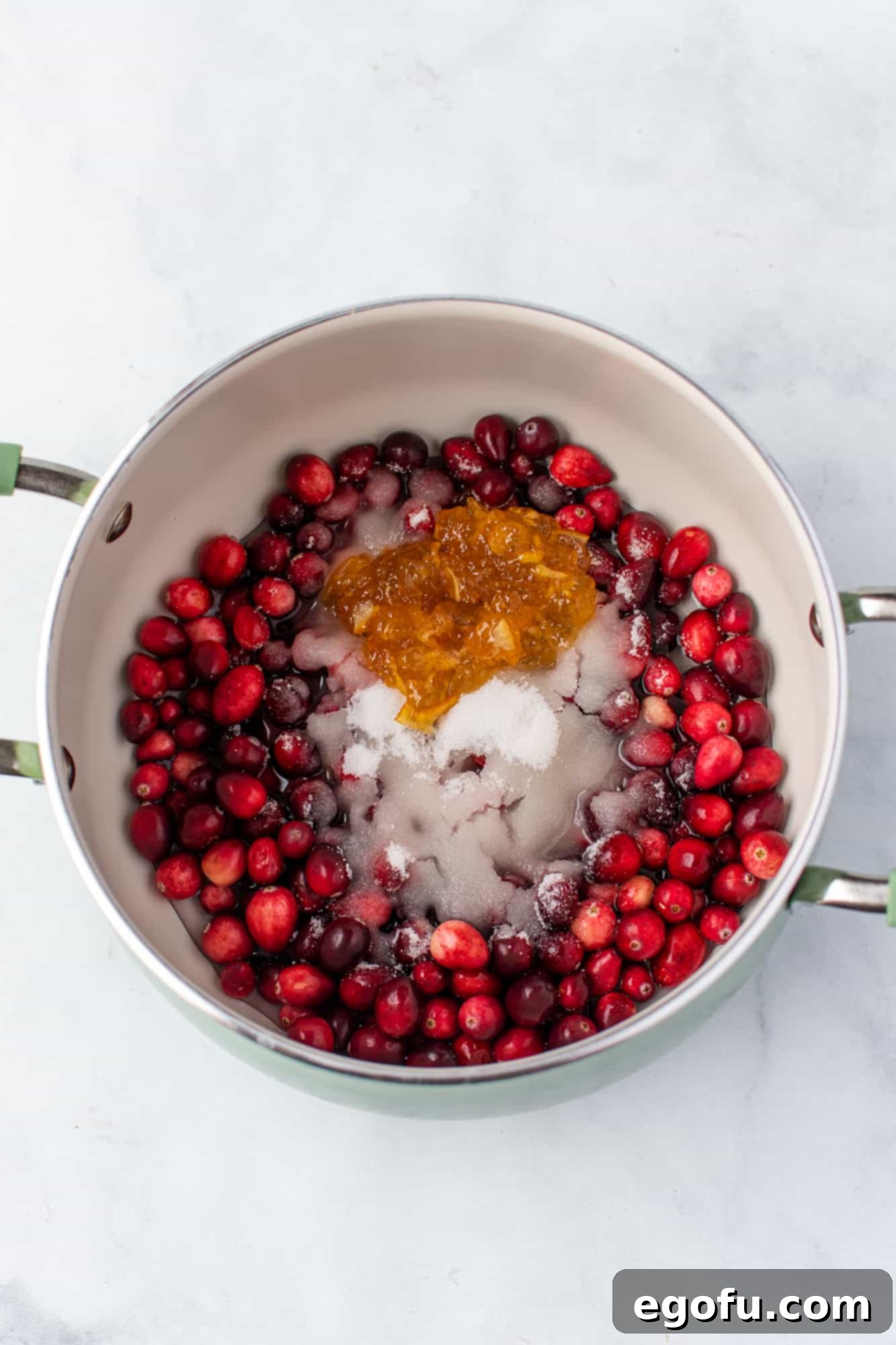 Effortless Cranberry Sauce 5 FRESH CRANBERRIES, WATER, SUGAR AND ORANGE MARMALADE IN A MEDIUM SAUCE PAN.