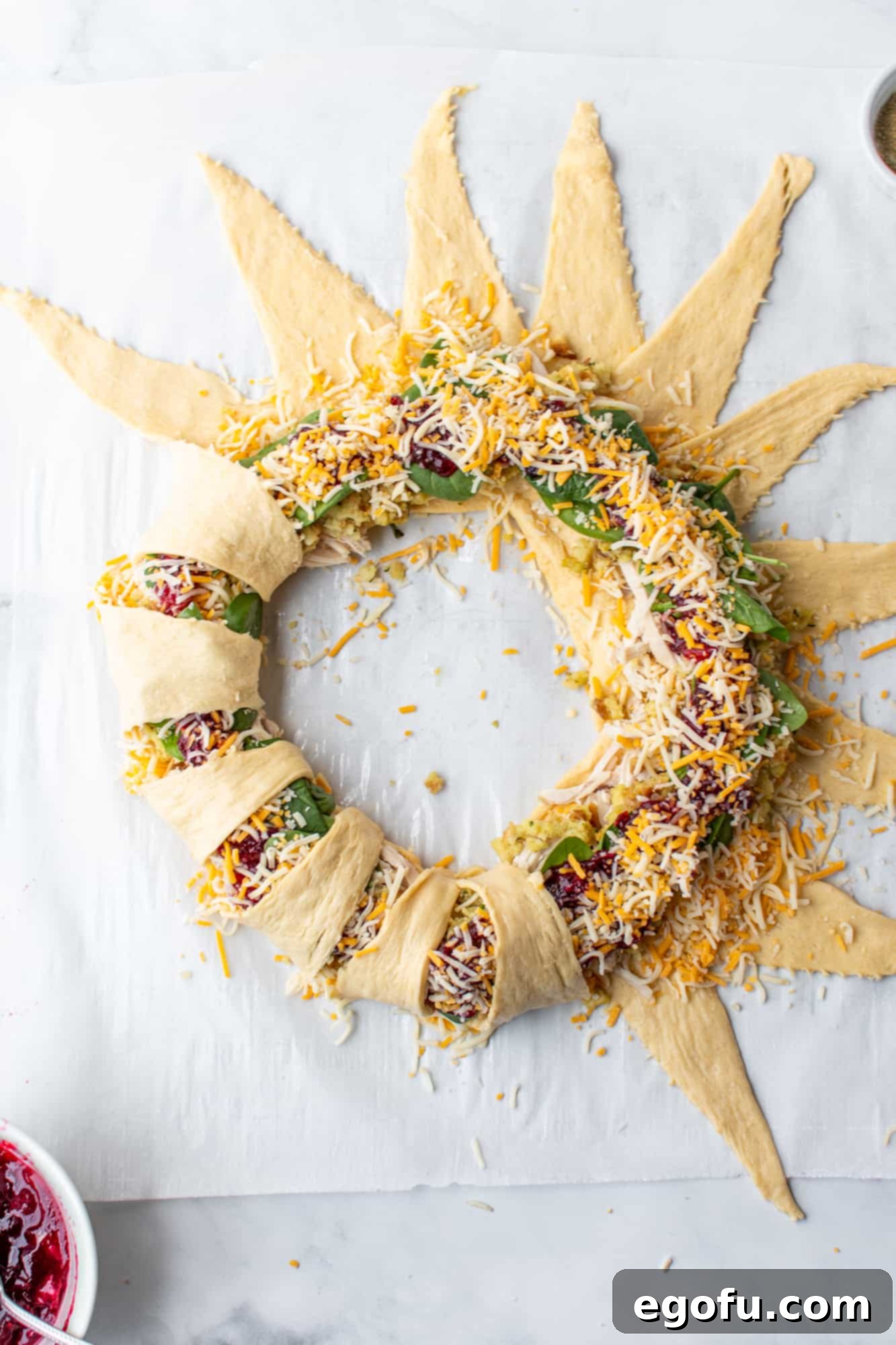 Festive Turkey Stuffing Crescent Bake 11 The crescent roll triangles are wrapped over the filling and tucked under the base, forming a complete, enclosed crescent ring.