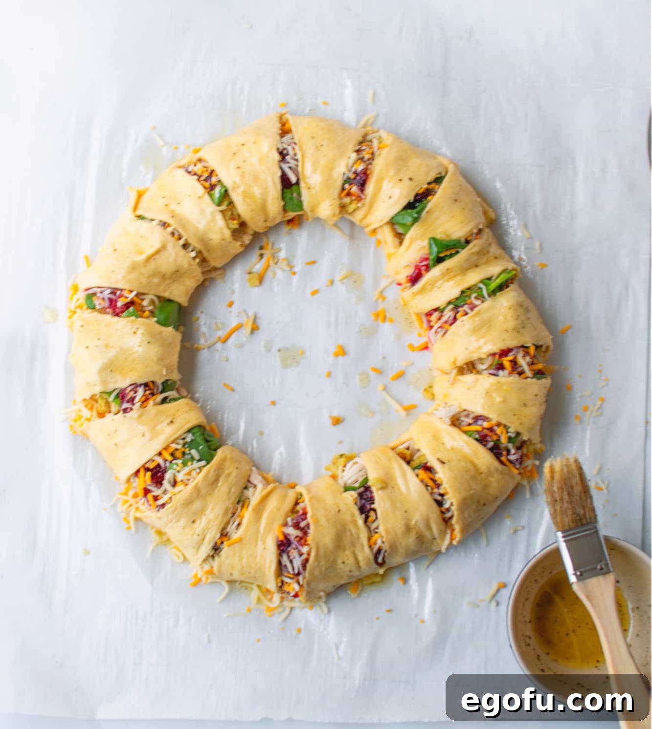 Festive Turkey Stuffing Crescent Bake 12 Melted butter mixed with poultry seasoning being brushed evenly over the crescent roll dough before baking, ensuring a golden crust.