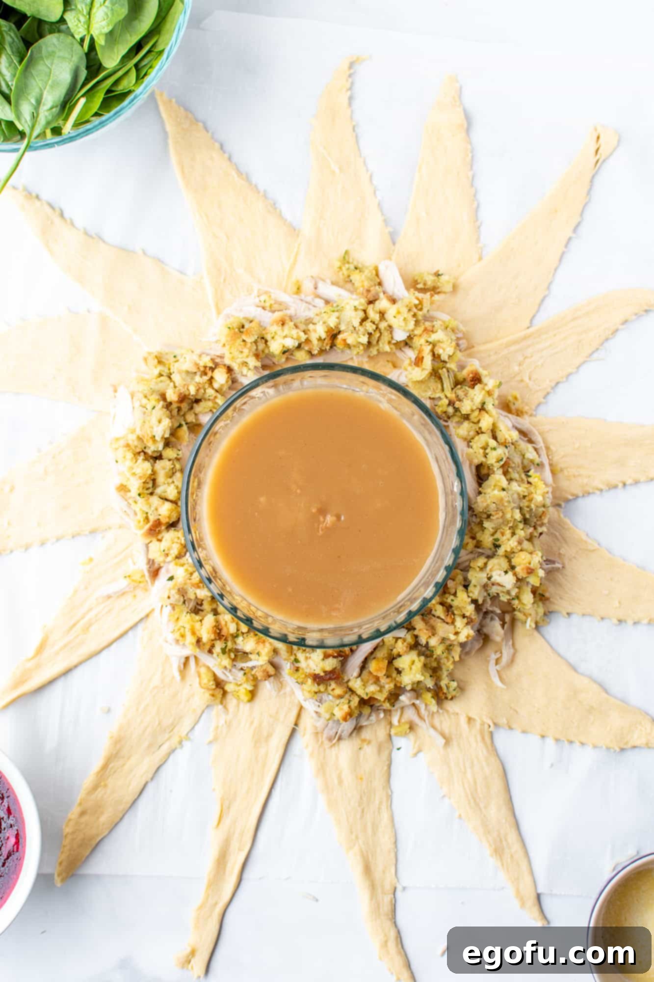 Festive Turkey Stuffing Crescent Bake 7 Cooked stuffing spread evenly over the turkey layer on the crescent rolls, creating a hearty filling.