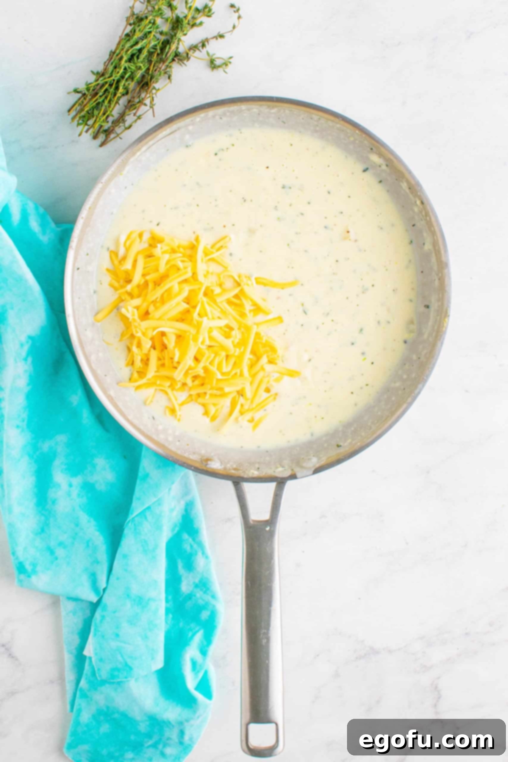 smoked shredded gouda cheese added to sauce pan.