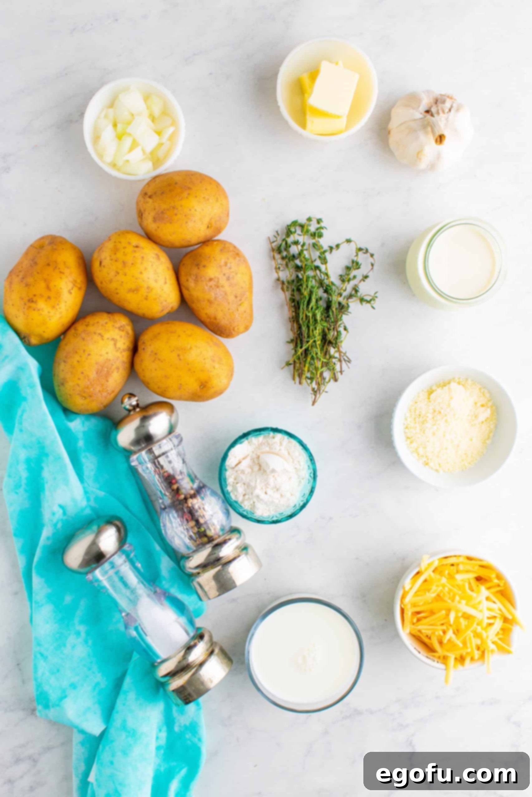 gold potatoes, unsalted butter, diced onion, kosher salt, black pepper, garlic, fresh thyme, all-purpose flour, whole milk, heavy cream, smoked gouda cheese, freshly grated parmesan cheese.