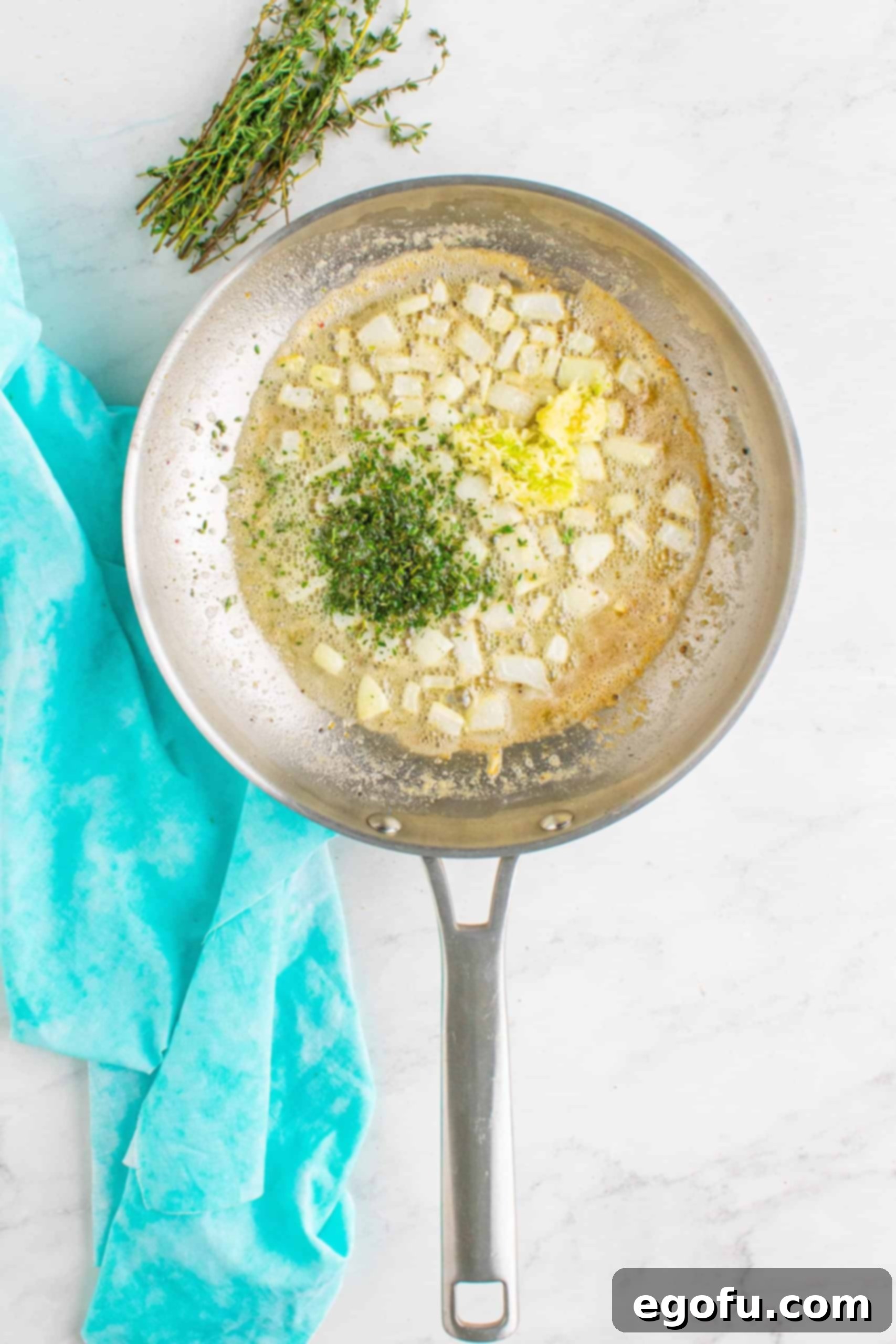 minced garlic and chopped time added to onions and butter in steel skillet.