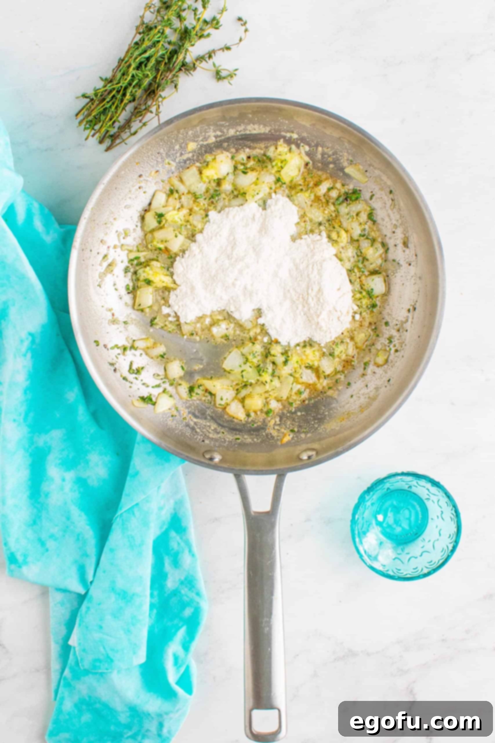 flour added to skillet with onion and garlic.