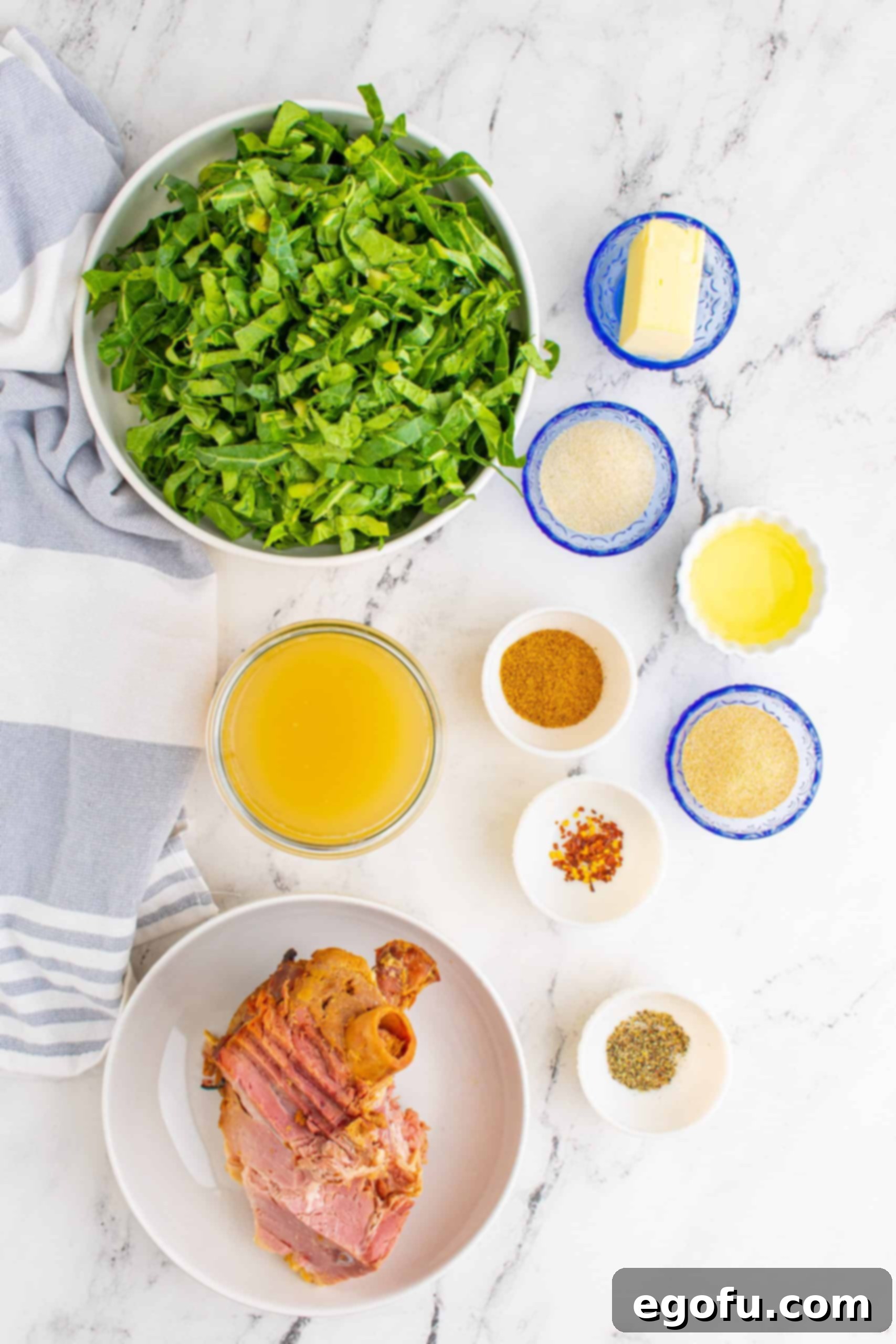 Ingredients for Collard Greens with Ham Bone: vegetable oil, ham bone, unsalted chicken stock, garlic powder, onion powder, chopped collard greens, seasoned salt, red chili flakes, unsalted butter.