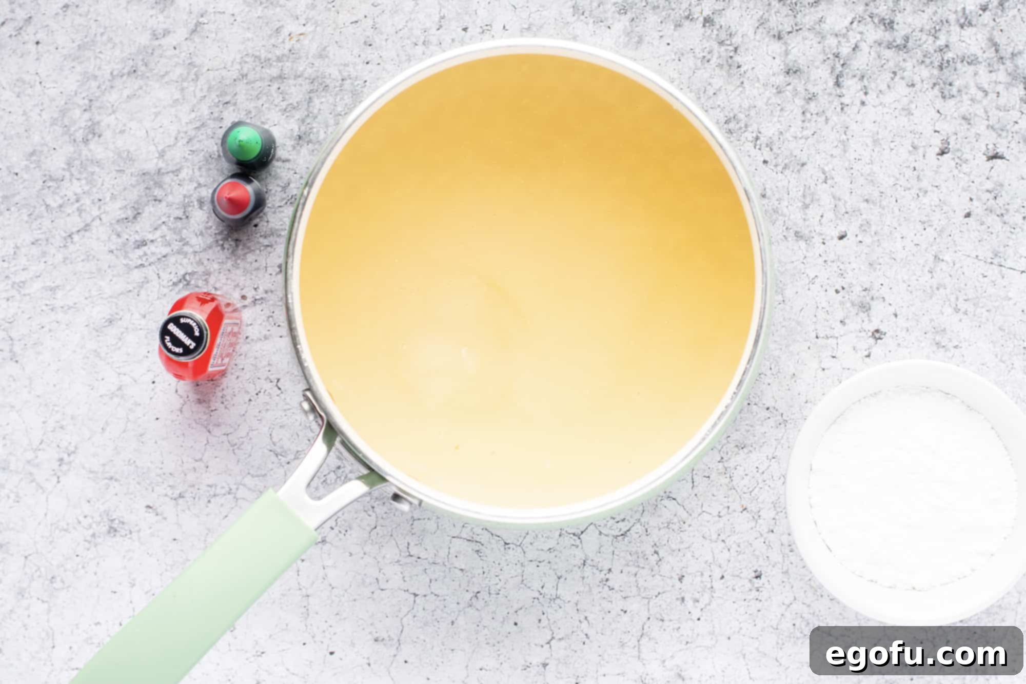 The cooking process showing apple juice, sugar, and corn syrup being combined in a saucepan on the stove.