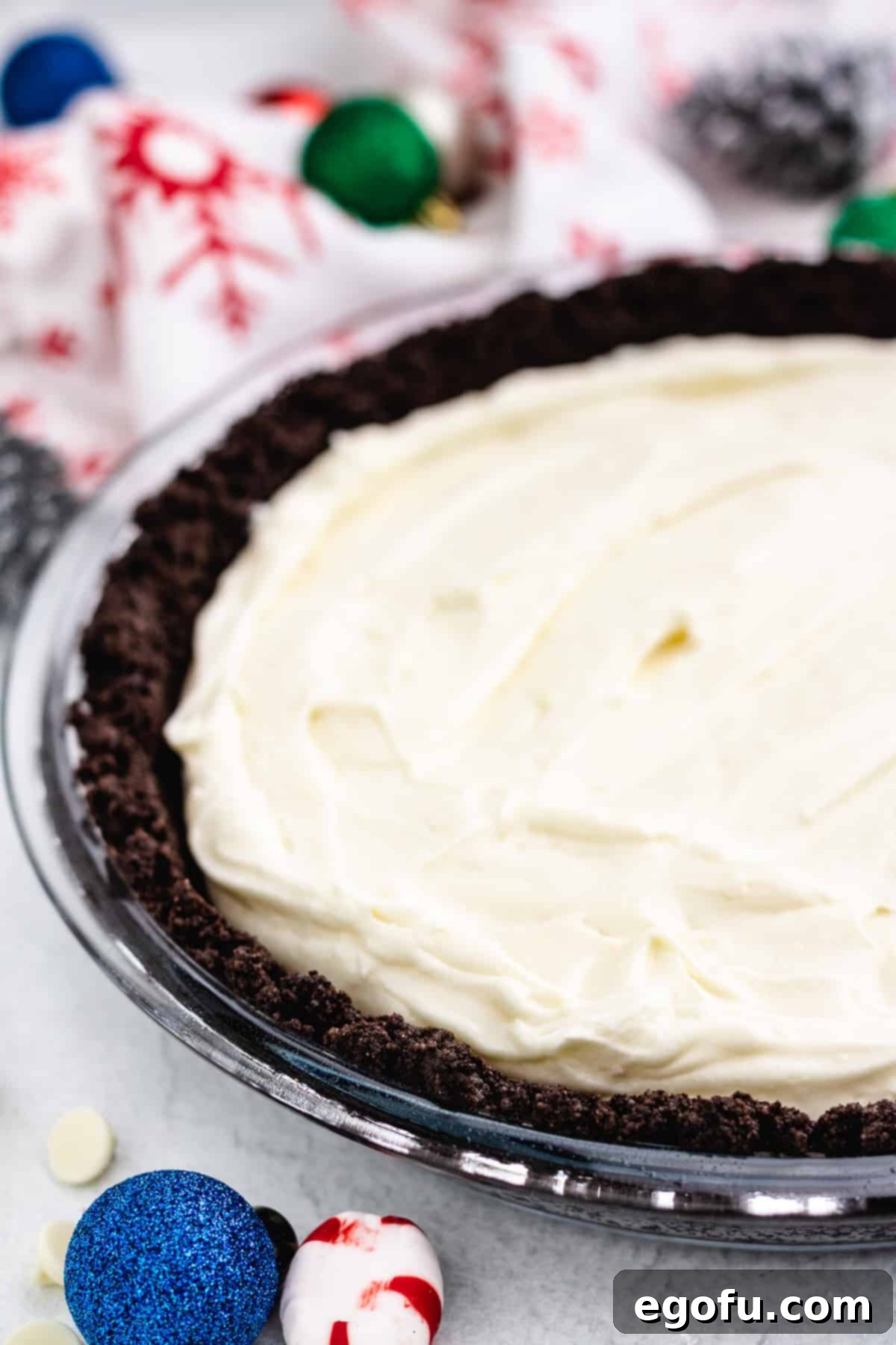 The smooth white chocolate peppermint cream filling carefully poured into the baked chocolate Oreo crust, ready for chilling.