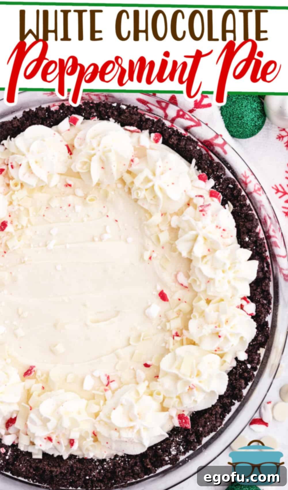 A stunning full view of the White Chocolate Peppermint Pie, elegantly presented with festive Christmas tree ornaments alongside, highlighting its holiday appeal.