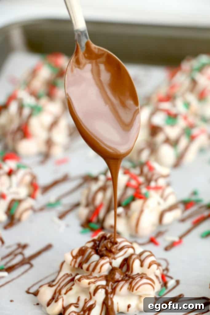 A spoon skillfully drizzling melted chocolate over the set peanut clusters, adding a decorative and flavorful touch.