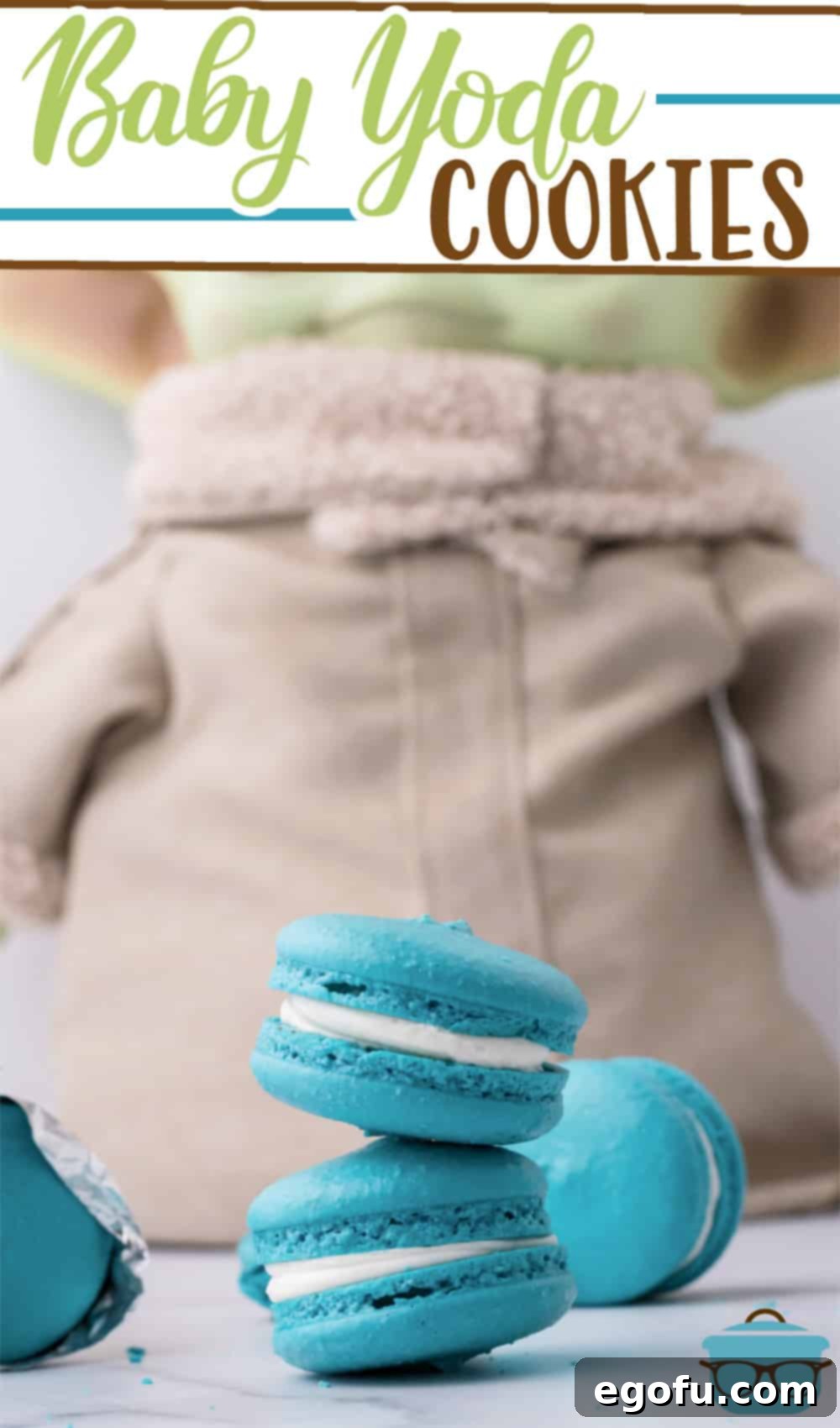 Adorable Baby Yoda doll stands proudly behind a stack of freshly baked teal blue Space Macarons, ready to be enjoyed. This Baby Yoda Cookie recipe is a sweet tribute to The Mandalorian series.