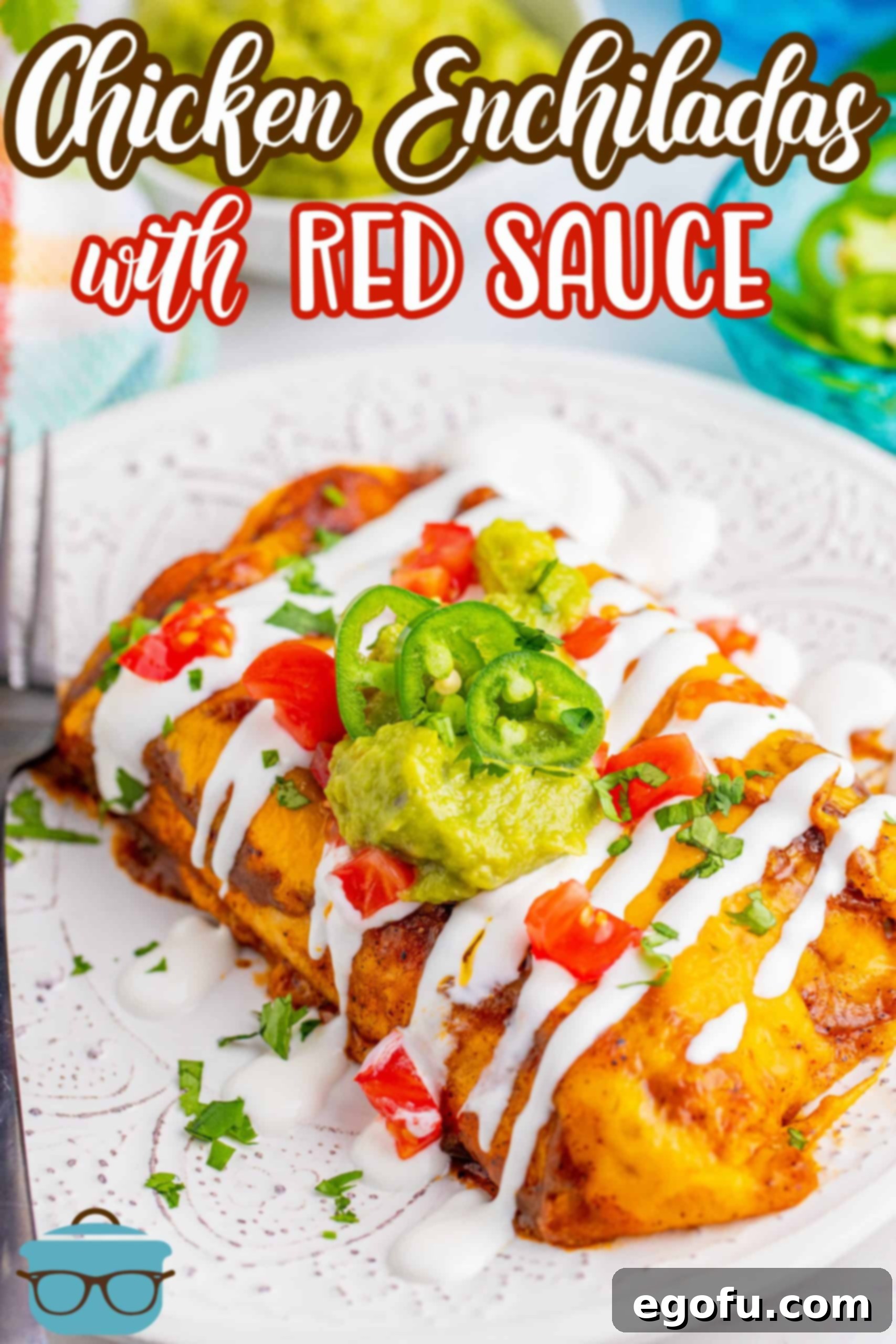 Chicken Enchiladas with homemade red enchilada sauce recipe from The Country Cook - two enchiladas shown on a white plate and topped with cream sauce, diced tomatoes, guacamole and fresh jalapeños.