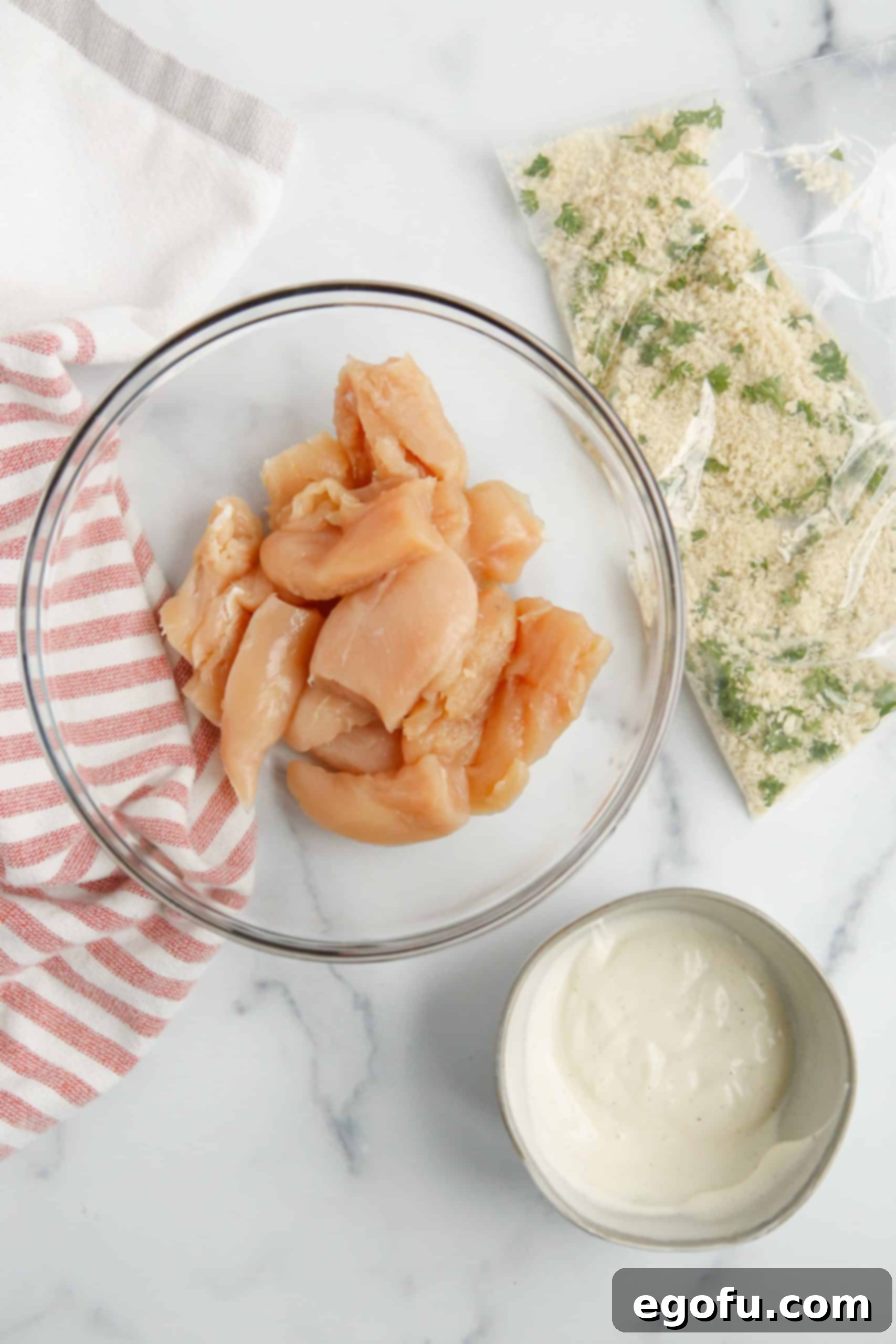 Diced chicken breast in a bowl with ranch and Panko breadcrumb mixture ready in a bag.