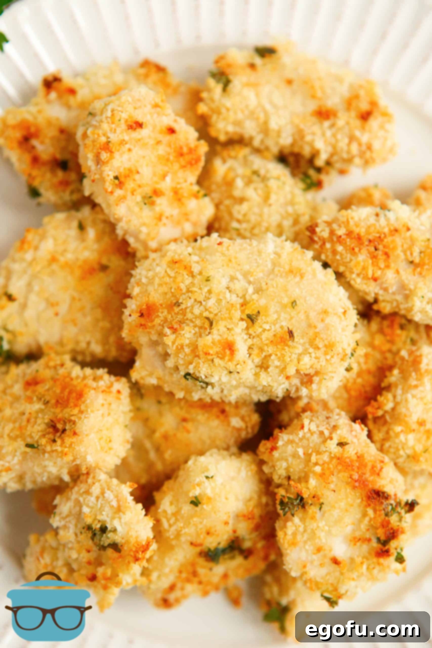 Closeup of stacked Ranch Chicken Nuggets on a white plate, highlighting texture.
