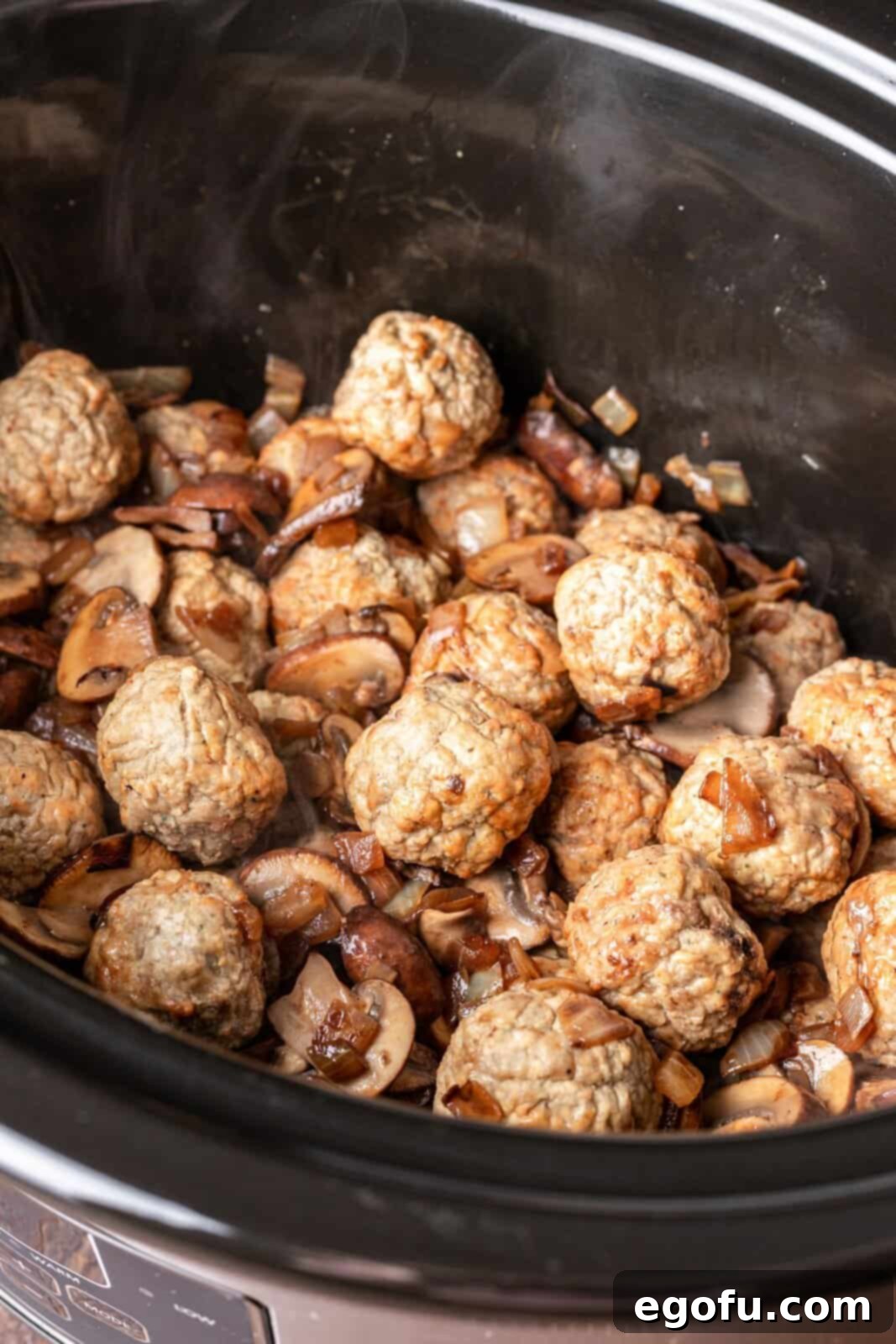 Frozen meatballs combined with sautéed onions and mushrooms in the slow cooker.