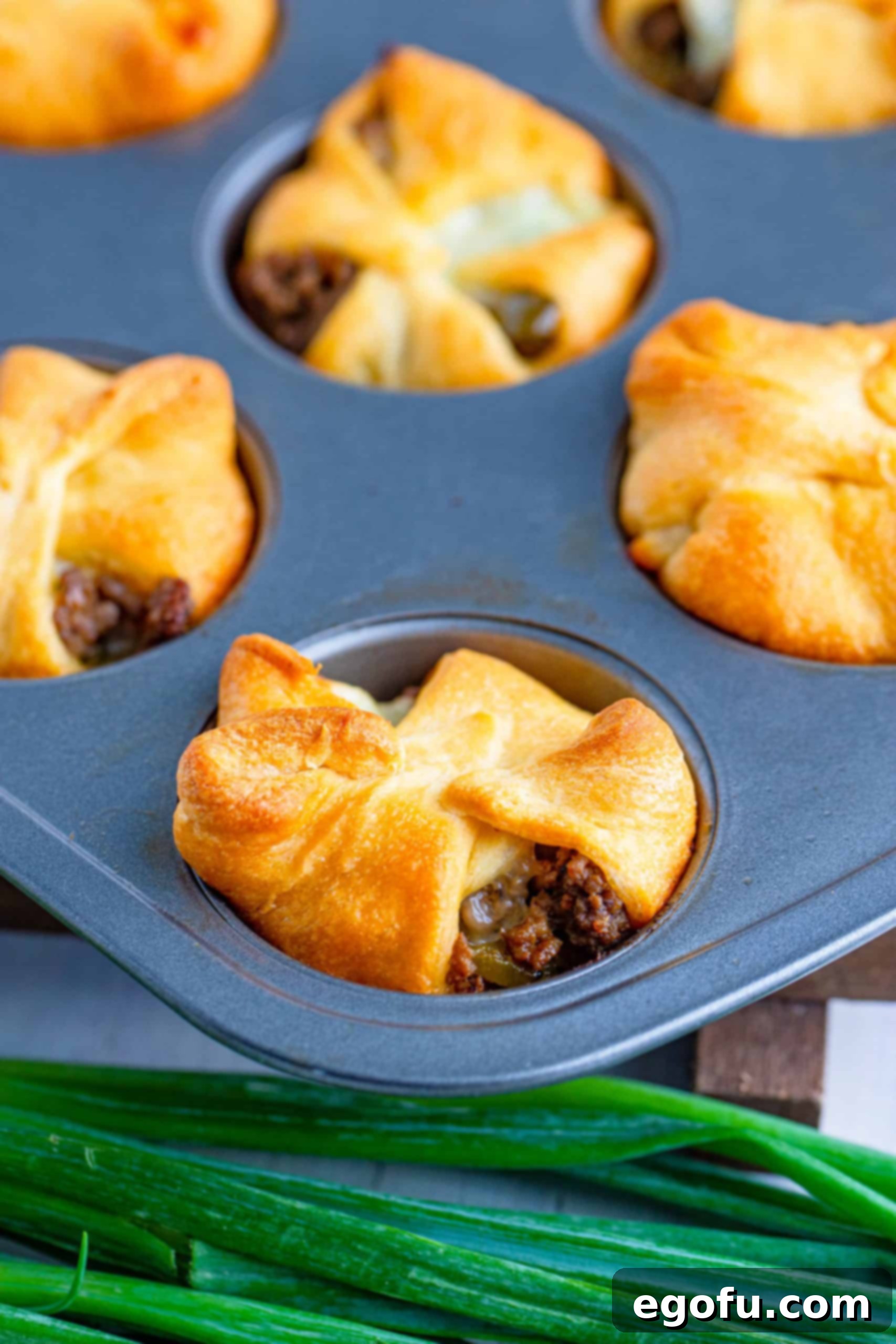 Philly Cheesesteak Poppers 12 Baked Philly Cheesesteak Cups in the muffin tin, golden brown and ready to serve.