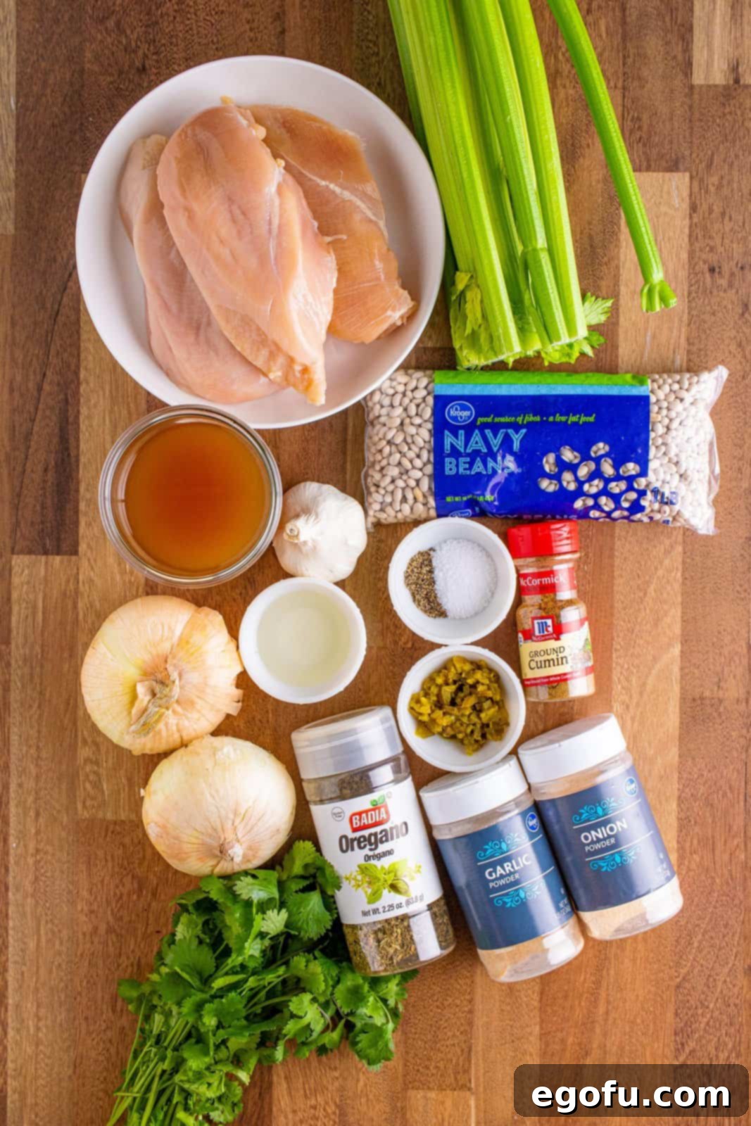 Creamy Crock Pot White Chicken Chili 5 navy beans, chicken breasts, onions, celery, garlic, garlic powder, onion powder, cumin, oregano, jalapeños and low sodium chicken stock.