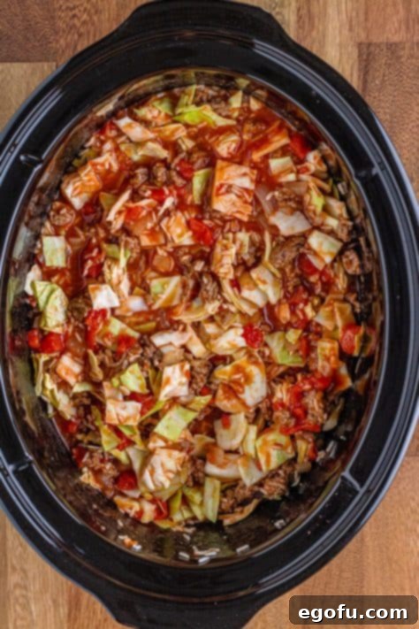 Unstuffed cabbage rolls cooking in a slow cooker.