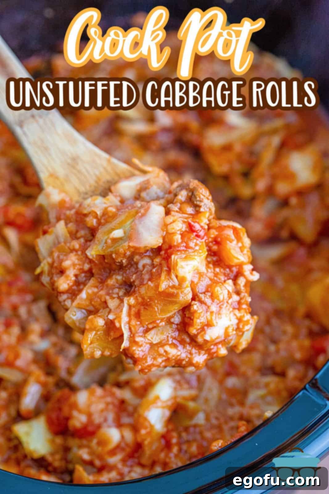 A wooden spoon holding up a generous serving of cooked unstuffed cabbage rolls over an oval slow cooker, showcasing its rich texture and appealing color.