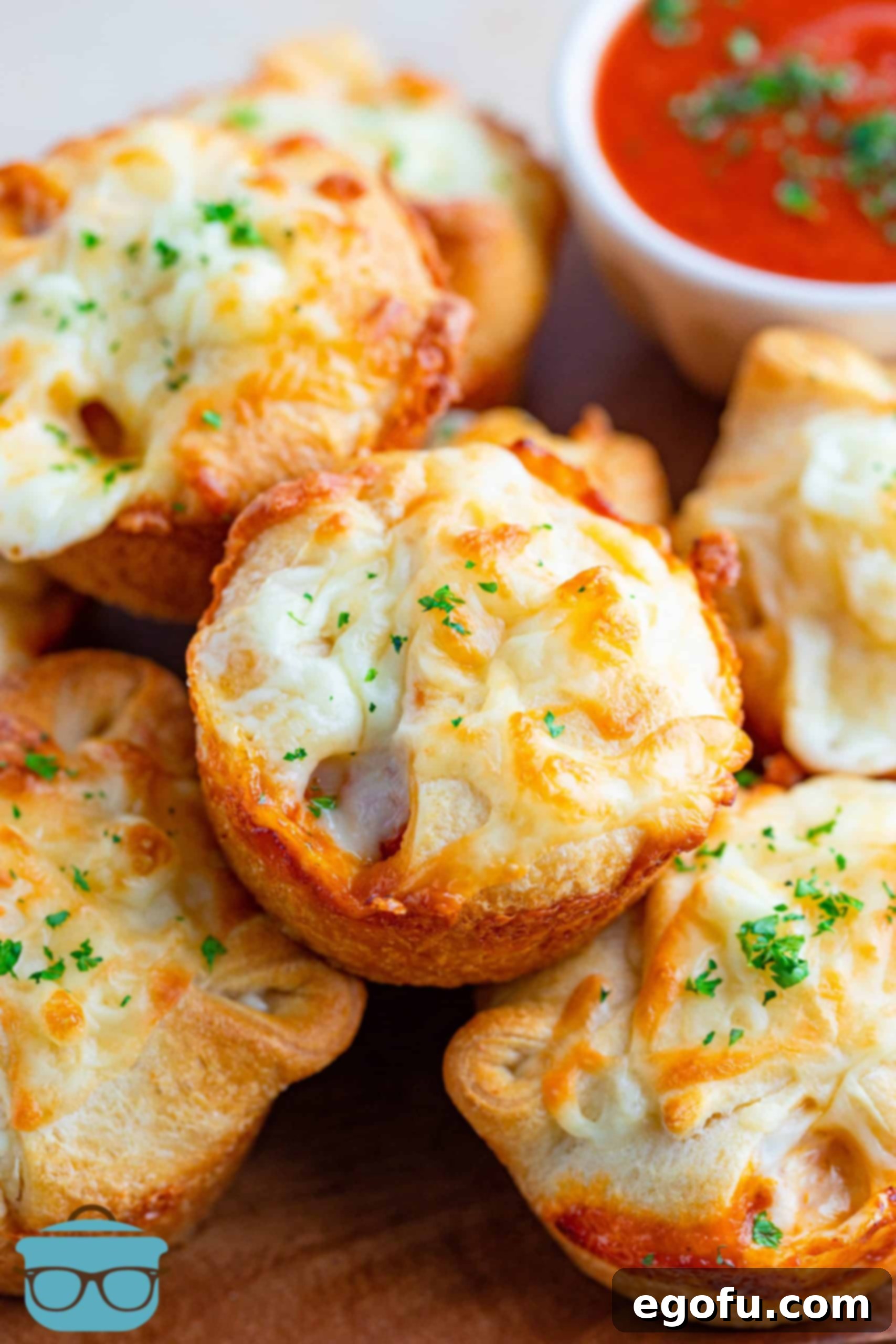 Stacked chicken parmesan cups on a plate, ready to be served, highlighting their golden-brown crust and cheesy filling.