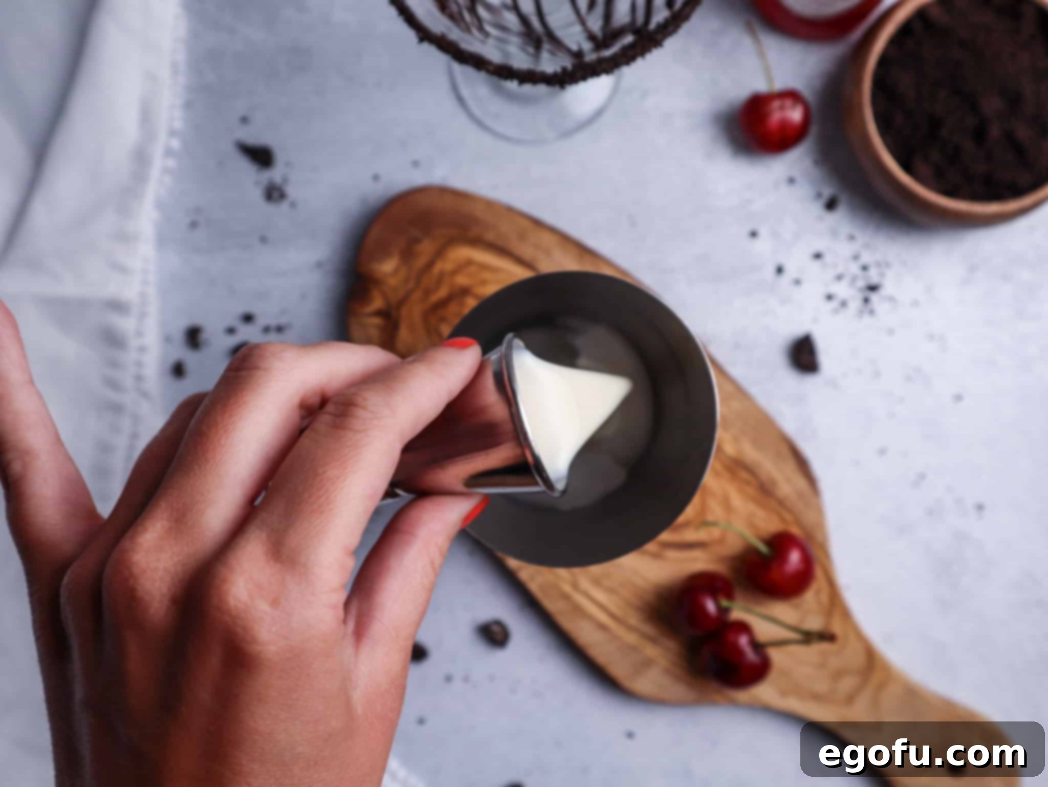 White Chocolate Irish Cream being added to a cocktail shaker, preparing for the rich and creamy base of the martini.