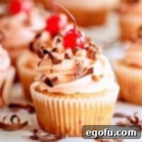 Close up of Cherry Chocolate Chip Cupcakes topped with a cherry and chocolate thumbnail