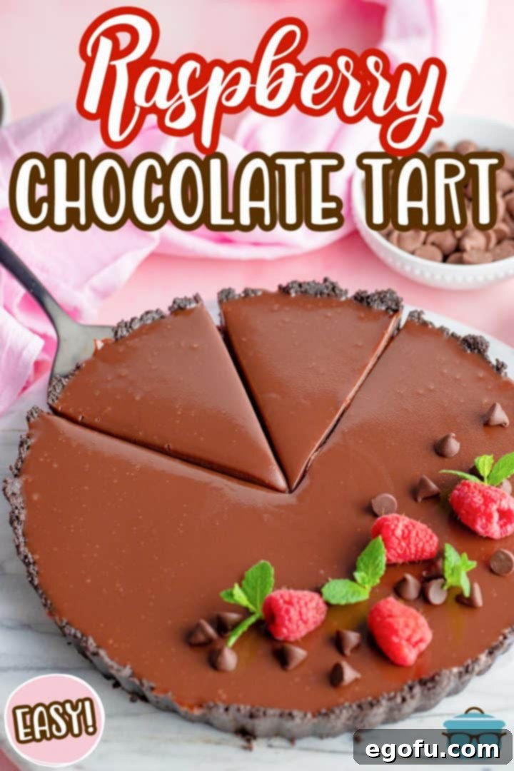 Decadent Raspberry Chocolate Tart 3 Raspberry Chocolate Tart with two slices already cut, showing the distinct layers of crust, raspberry, and ganache.