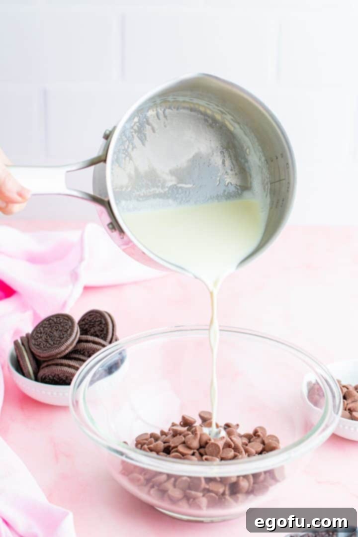 Decadent Raspberry Chocolate Tart 8 Hot heavy cream being poured over chocolate chips in a mixing bowl.