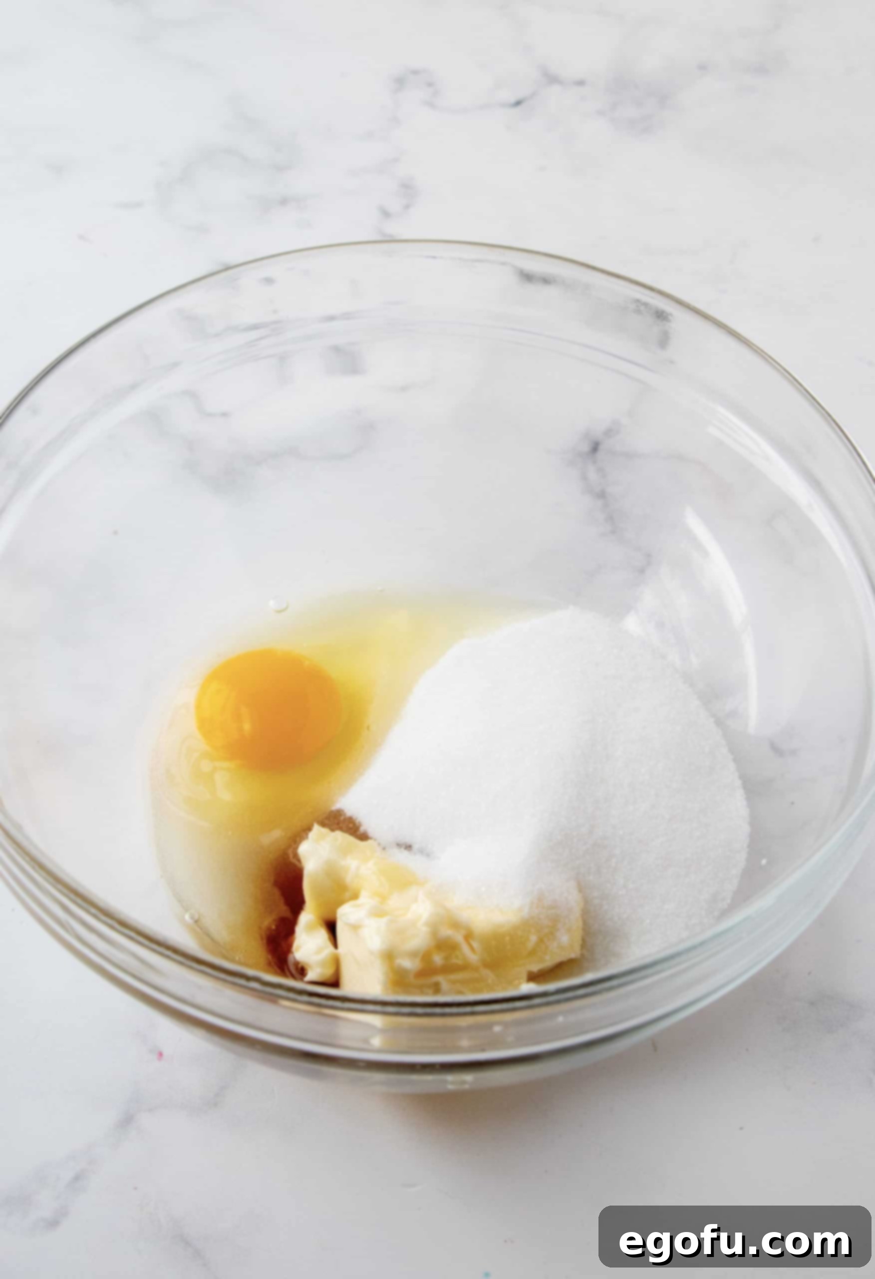 Crimson Raspberry Flip Cake 11 Butter, sugar, egg and vanilla in bowl.