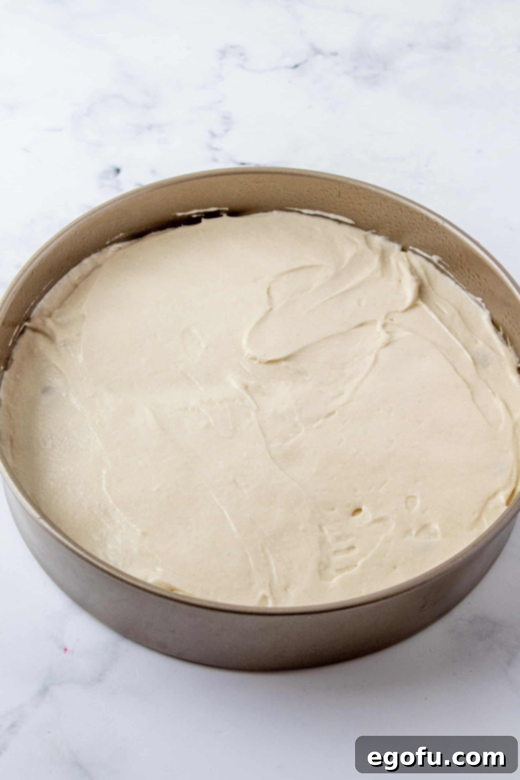 Crimson Raspberry Flip Cake 17 Cake batter spread over raspberries in pan.