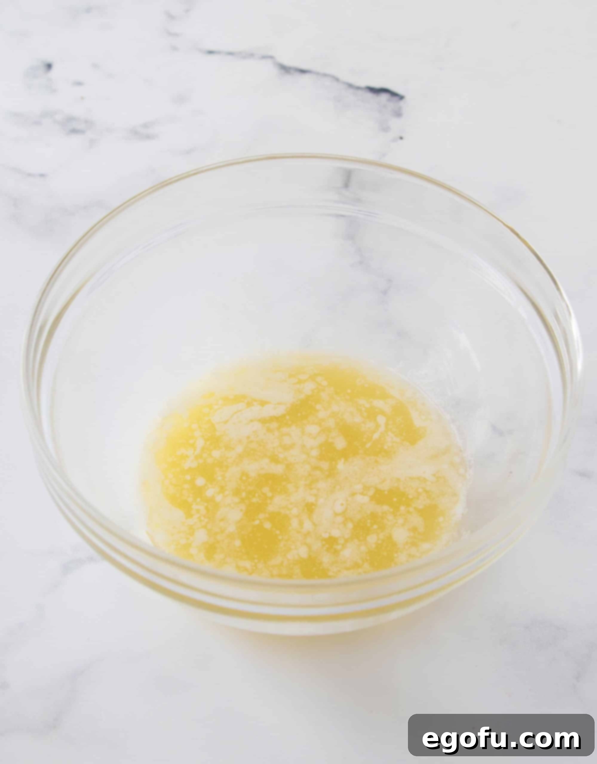 Crimson Raspberry Flip Cake 4 Melted butter in a clear bowl.