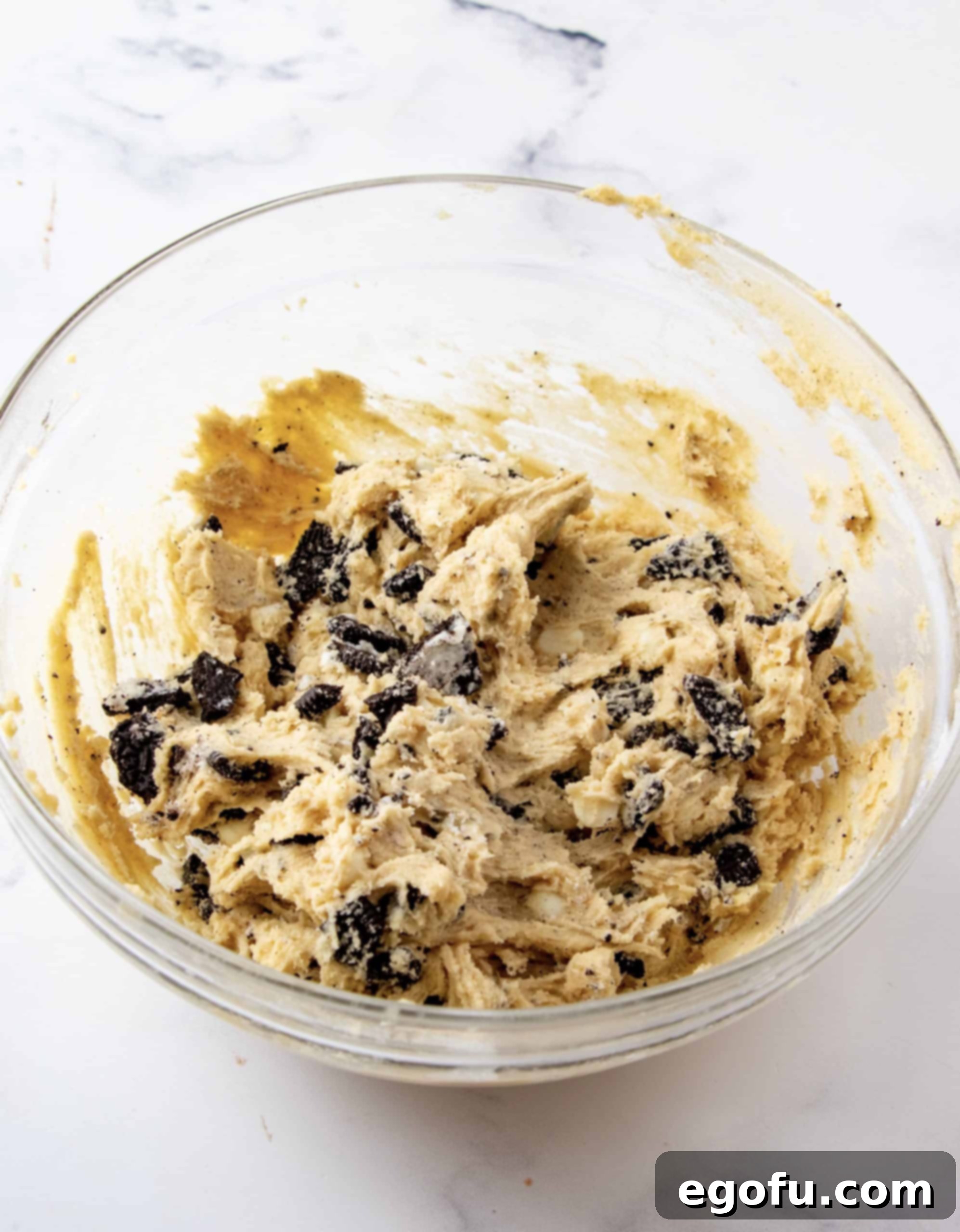 White chocolate chips and Oreos folded into dough.