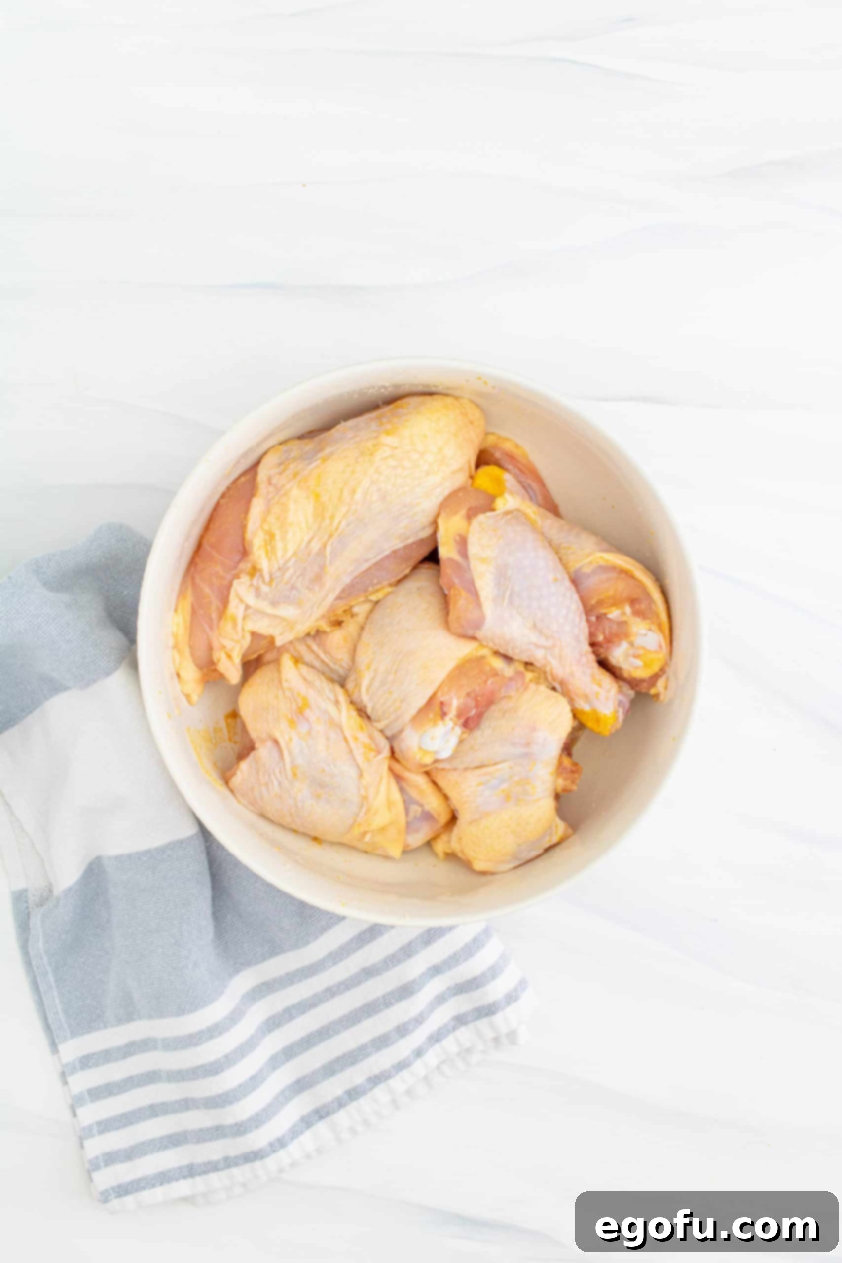 cut up chicken in a white bowl.